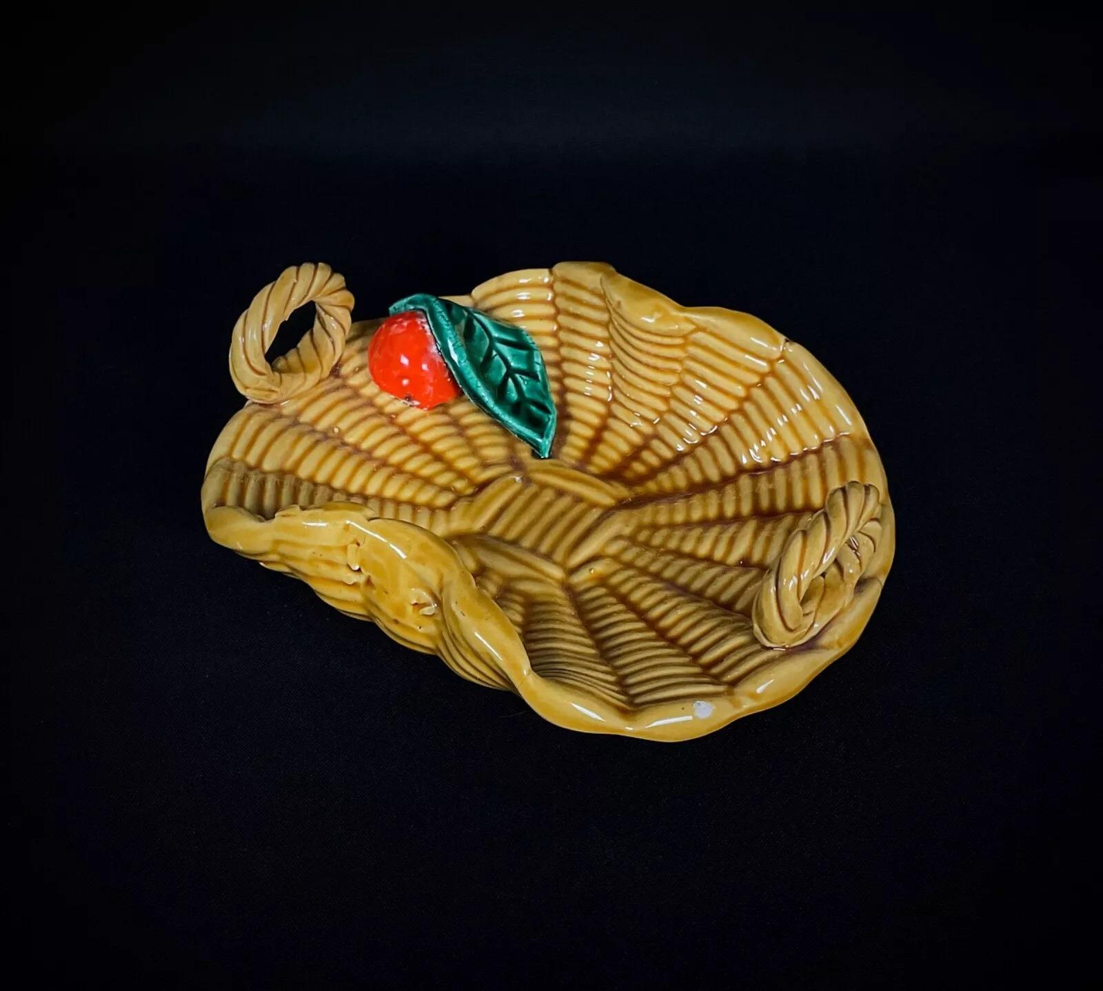 This rare vintage trinket dish from Vallauris is a charming piece crafted in the shape of a basket and adorned with delightful fruit decor. A perfect blend of functionality and artistic craftsmanship, it is an eye-catching accent for collectors or