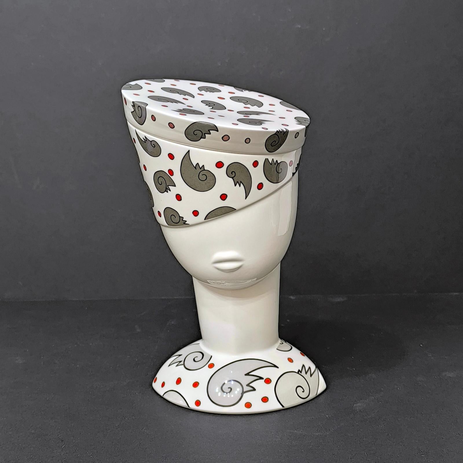 This is a gorgeous and hard-to-find sculptural porcelain box with a lid. It is shaped like a woman's head with a hat; the top of the hat forms the lid. It is not only a highly decorative item but also useful and can be used to store small items.
By
