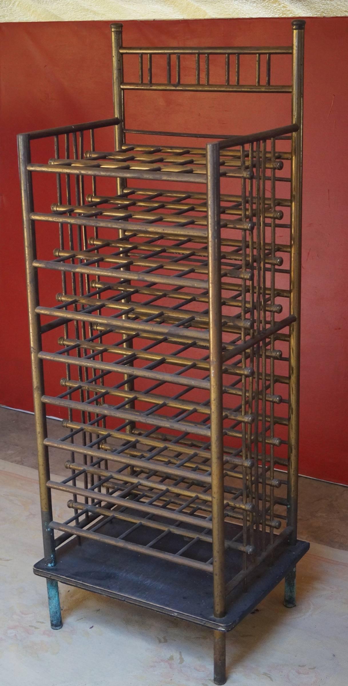 Rare vintage wooden and brass wine rack, France, 1970s.

Quite a special wine rack where the bottles are put in the sides in stead of the front.
Place for 36 bottles of wine.

Vintage condition with beautiful patina.
Measures: H x W x D 129cm