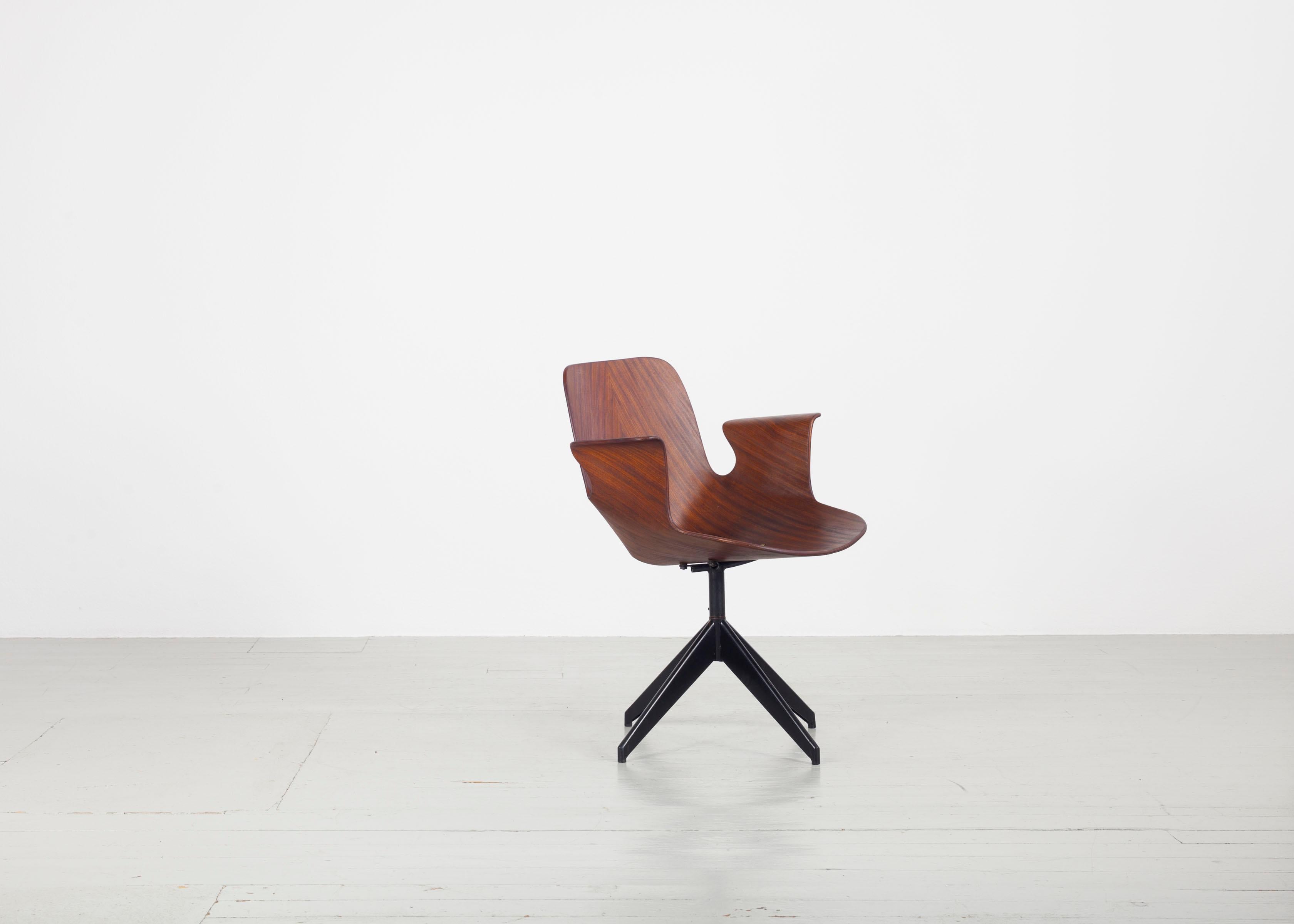 This 1950s swivel office chair “Medea” was designed by Vittorio Nobili and manufactured by Fratelli Tagliabue in Meda, Italy. The teak plywood seat swivels in all directions on a dark iron frame, making it an ideal office chair. In addition, it