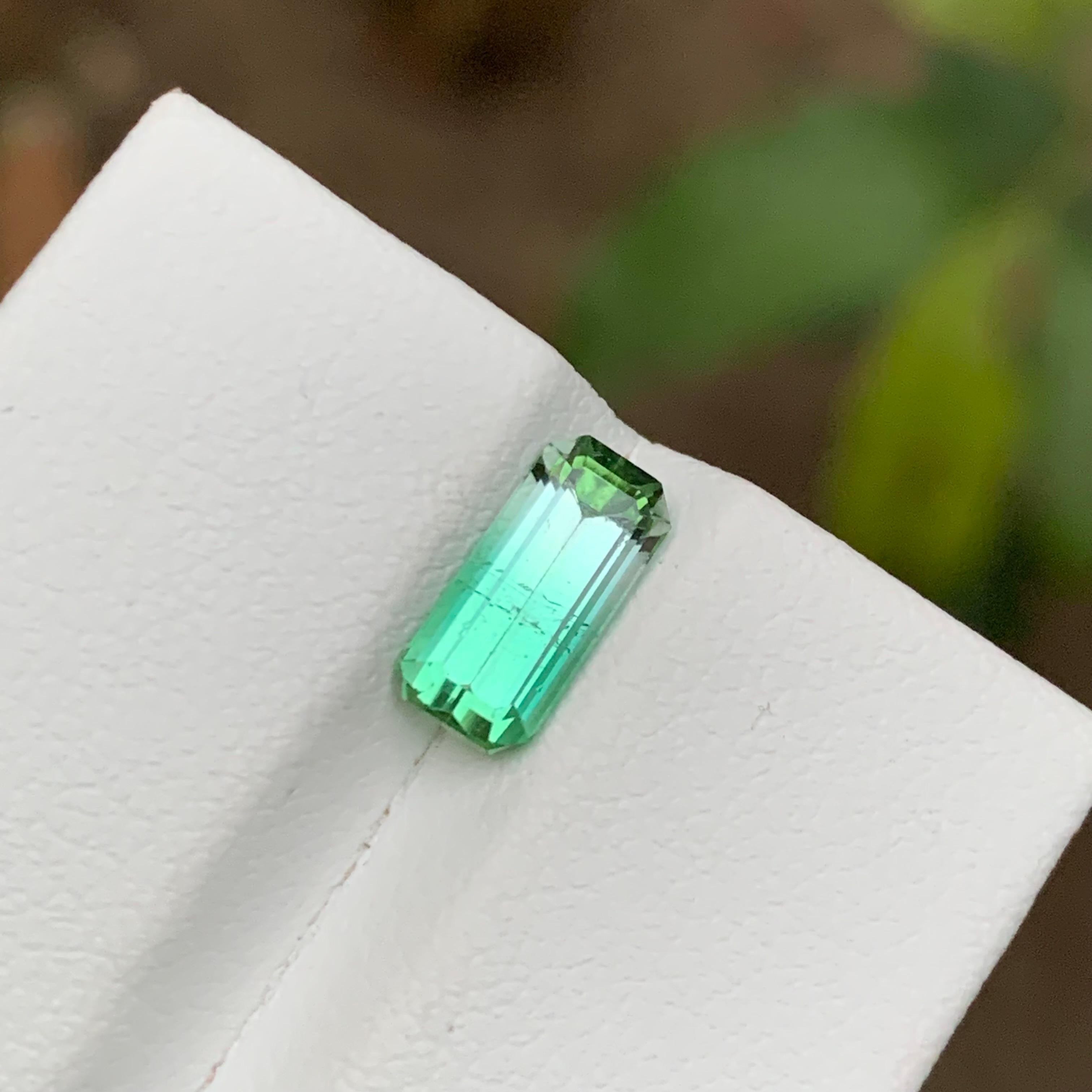 GEMSTONE TYPE: Tourmaline
PIECE(S): 1
WEIGHT: 1.70 Carats
SHAPE: Emerald
SIZE (MM): 9.98 x 4.68 x 4.11
COLOR: Neon Bluish Green
CLARITY: Slightly Included 
TREATMENT: None
ORIGIN: Afghanistan
CERTIFICATE: On demand

Indulge in the allure of natural