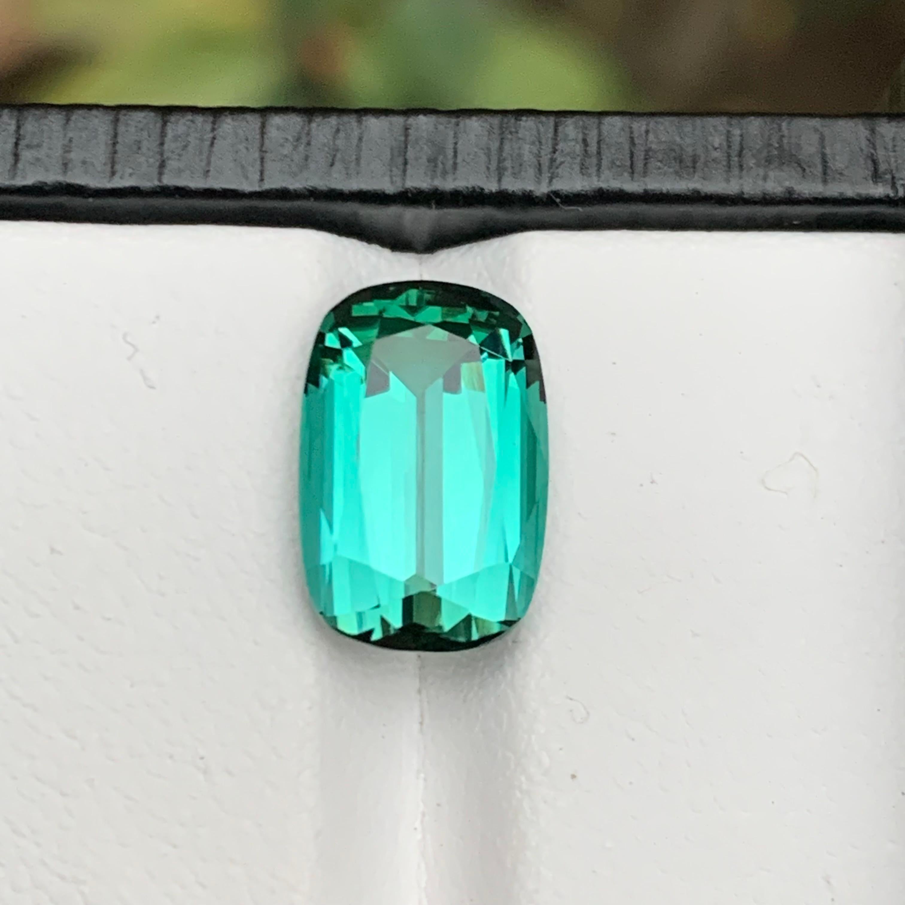 Extraordinary Step Cushion Cut Vivid Seafoam Natural Tourmaline. Mined in Afghanistan, this rare gemstone weighs 5.55 carats and boasts a mesmerizing luster with impeccable loupe clean clarity. Perfect for those seeking a distinctive touch, it's an