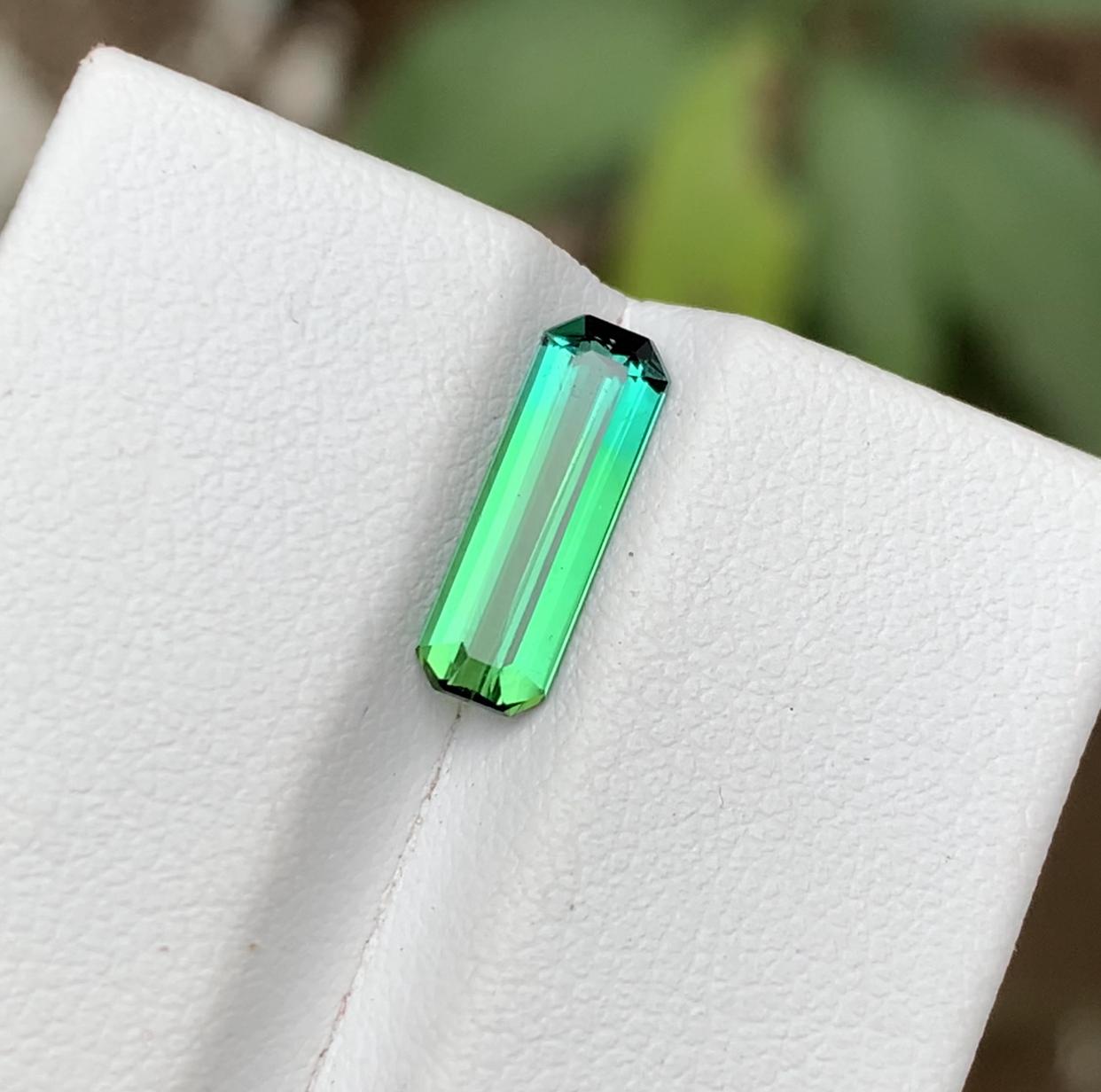 GEMSTONE TYPE: Tourmaline
PIECE(S): 1
WEIGHT: 1.50 Carats
SHAPE: Emerald
SIZE (MM): 12.58 x 4.20 x 2.99
COLOR: Vivid Neon Green & Blue Bicolor
CLARITY: Approx Eye Clean
TREATMENT: None
ORIGIN: Afghanistan
CERTIFICATE: On demand

Truly exquisite 1.50