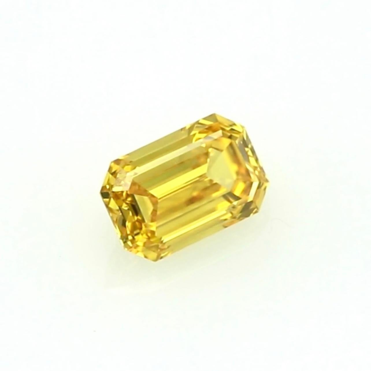  Presenting a rare and breathtaking 0.82-carat Fancy Vivid Yellow Diamond in an elegant emerald cut. This gem boasts an intense, vivid yellow hue, a color grade highly sought after for its rarity and unmatched brilliance. The emerald cut enhances