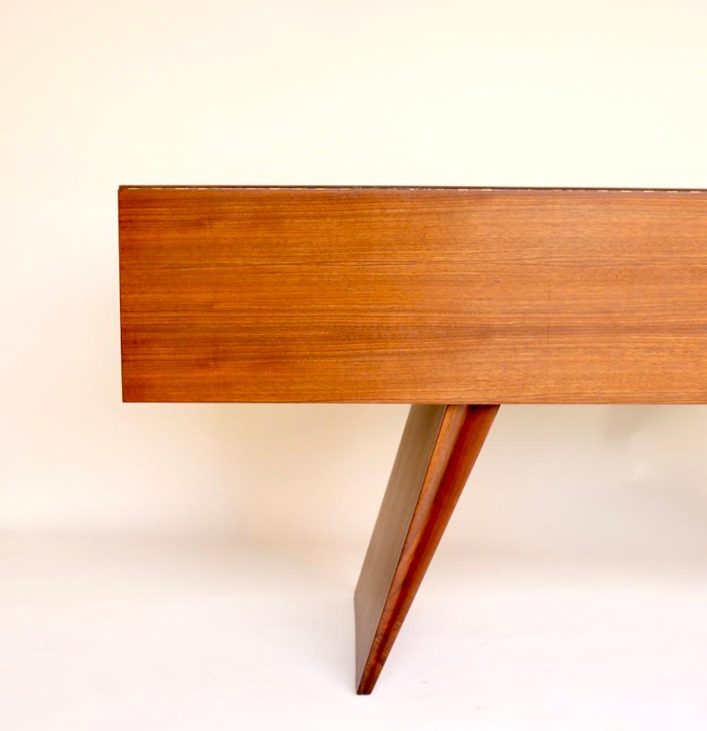 This is a very rare early Vladimir Kagan Console Table or Dining Table designed in circa 1950. This table was executed in walnut. The table can be used as a beautiful console table with incredible geometric lines. Extend the solid walnut apron on