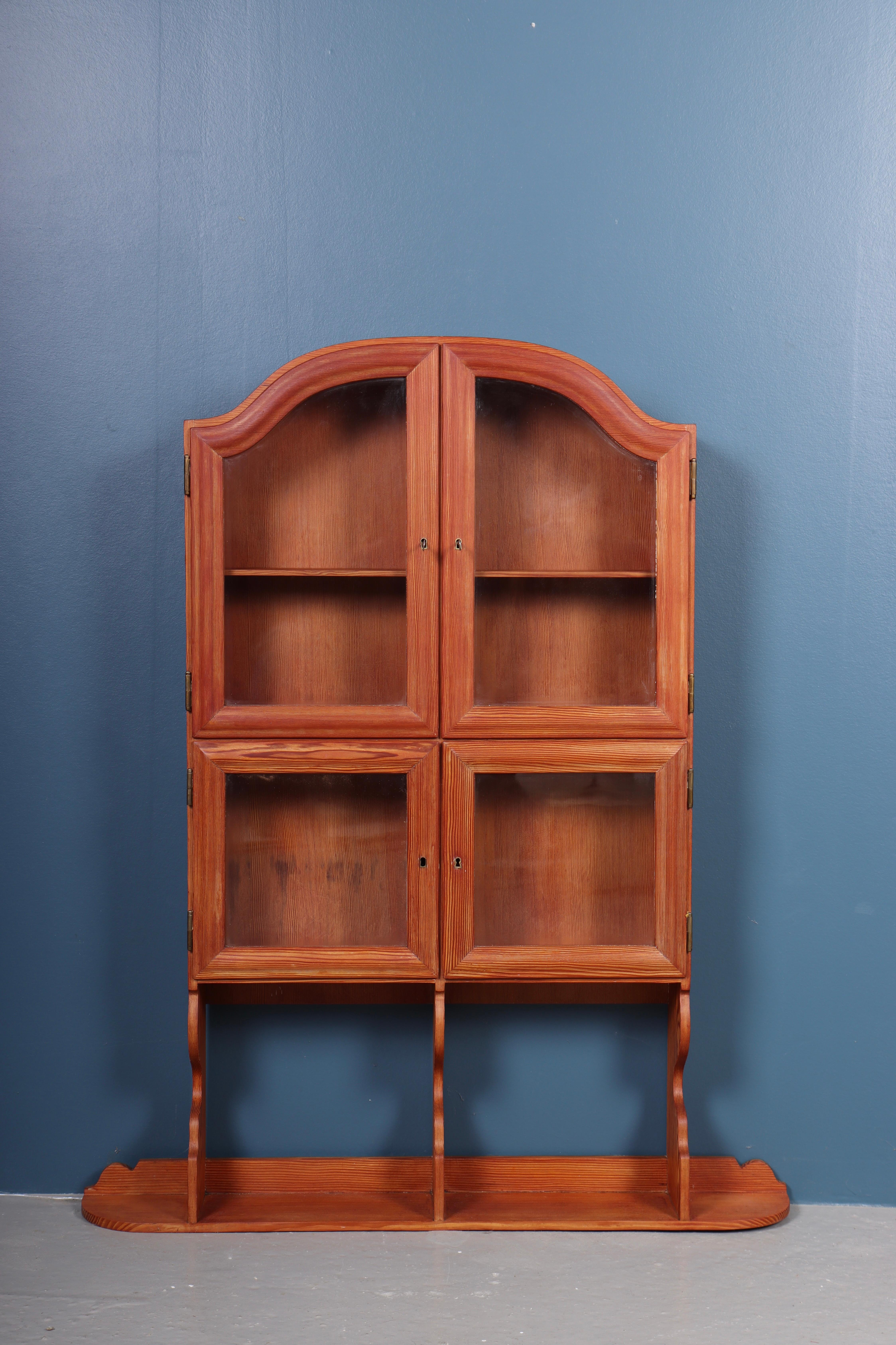 Very rare wall display cabinet in patinated solid pine. Designed by MAA. Martin Nyrop as interior for Bispebjerg hospital in 1913. Made in Denmark by Cabinetmaker Rud Rasmussen cabinetmakers. Great original condition.

