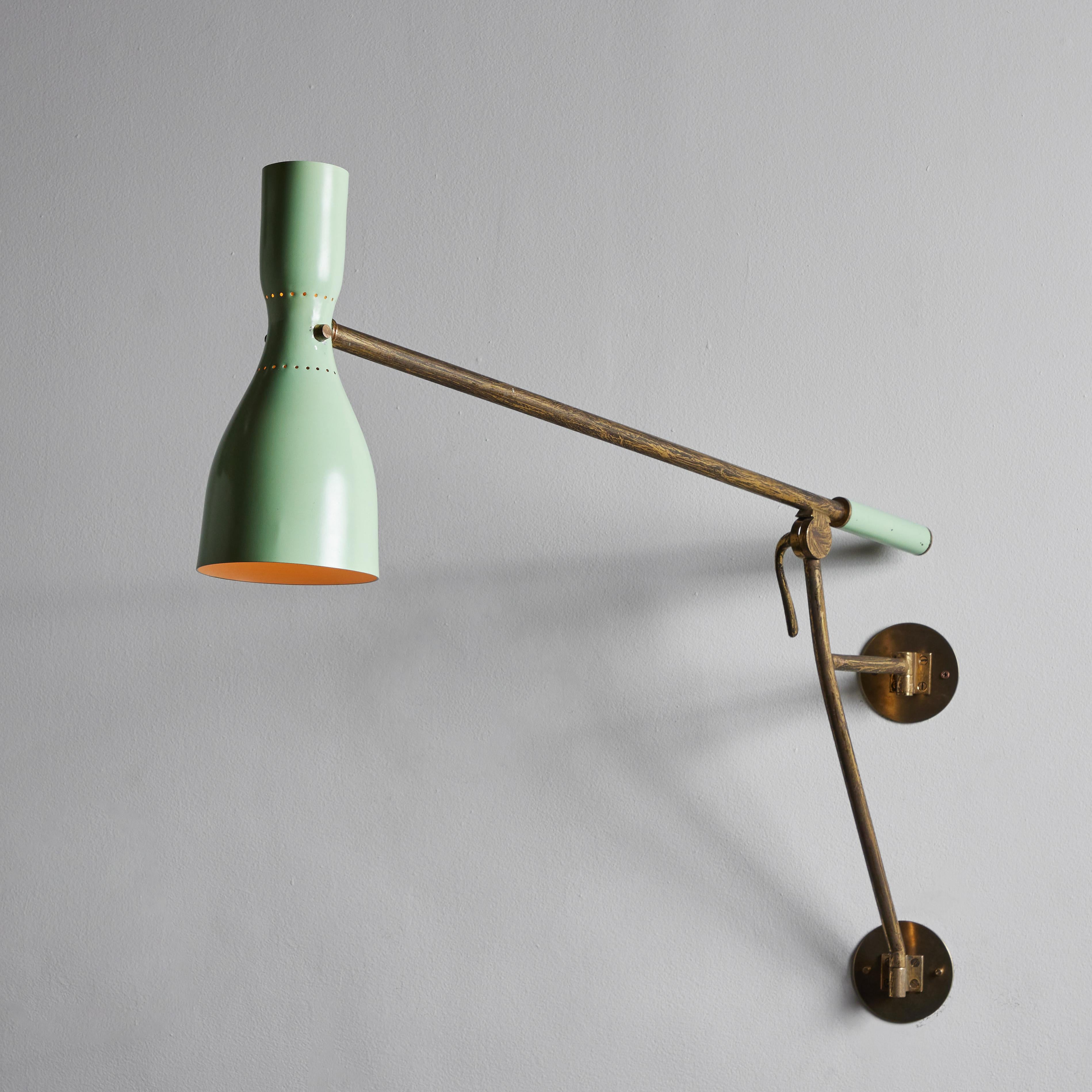 Rare wall light by Stilnovo. Designed and manufactured in Italy, circa 1952. Enameled metal, brass. Custom Brass backplate. Shade and arm adjust to various positions. We recommend one E14 European candelabra 60w maximum bulb. Bulbs provided as a one