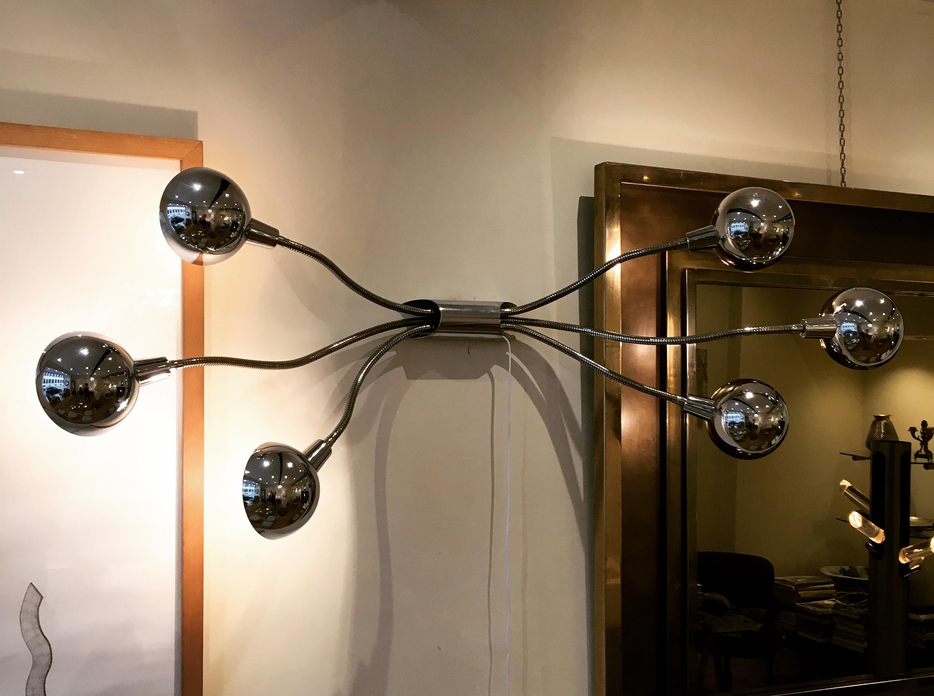 Rare applique by the French designer Pierre Folie, known as “Hydra”. It dates circa 1960s. It is made of chrome metal. All the arms are movable in any direction.

Please not that the size from bottom to top straight arms is 170cm.