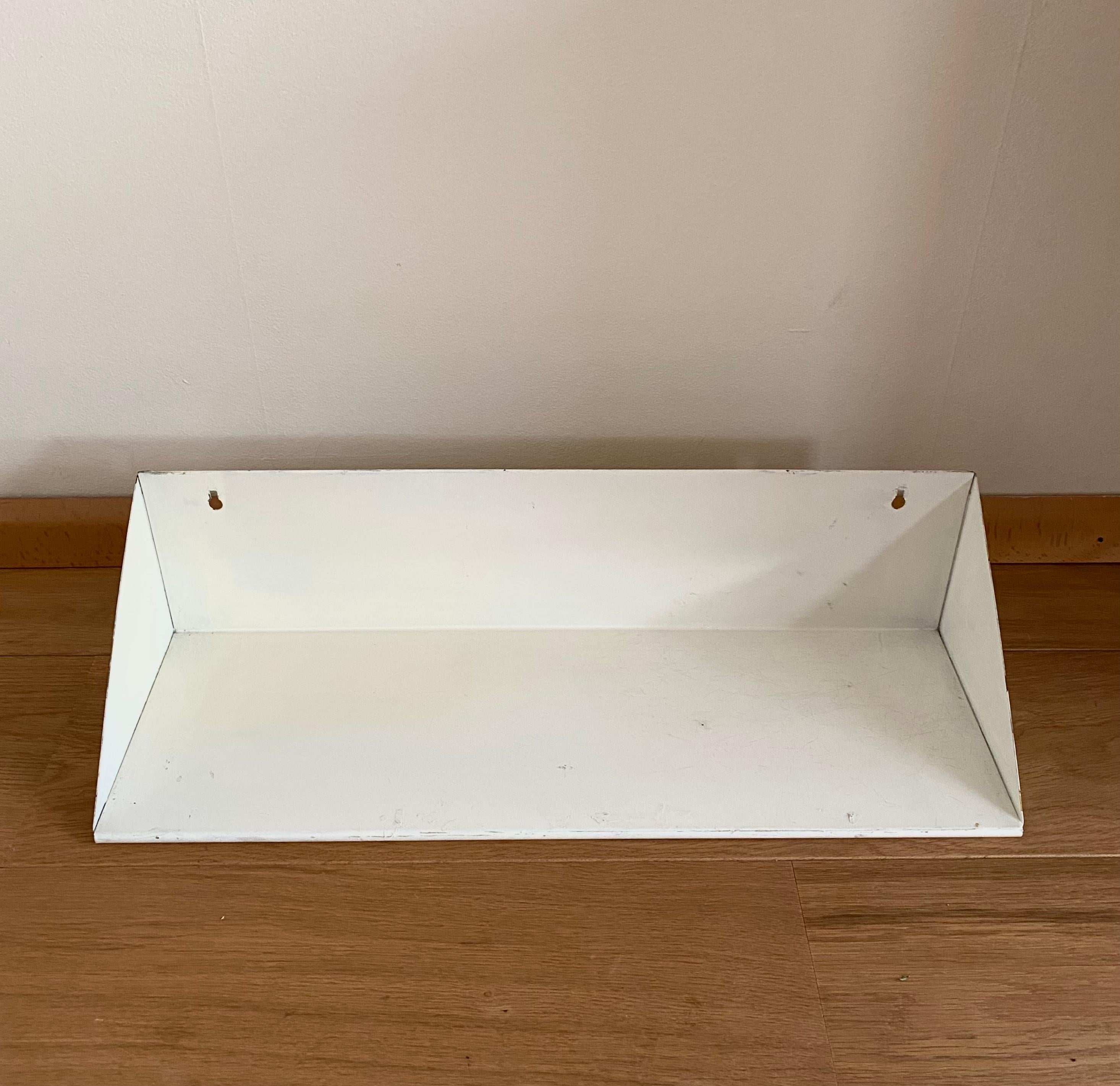 Very rare metal wall shelf designed by Dutch artist and designer Constant Nieuwenhuys for Asmeta (ASsendelftse METAalwarenfabriek).

The shelf remains in good condition with light wear, such as thin scratches, some discoloration (yellowed at the