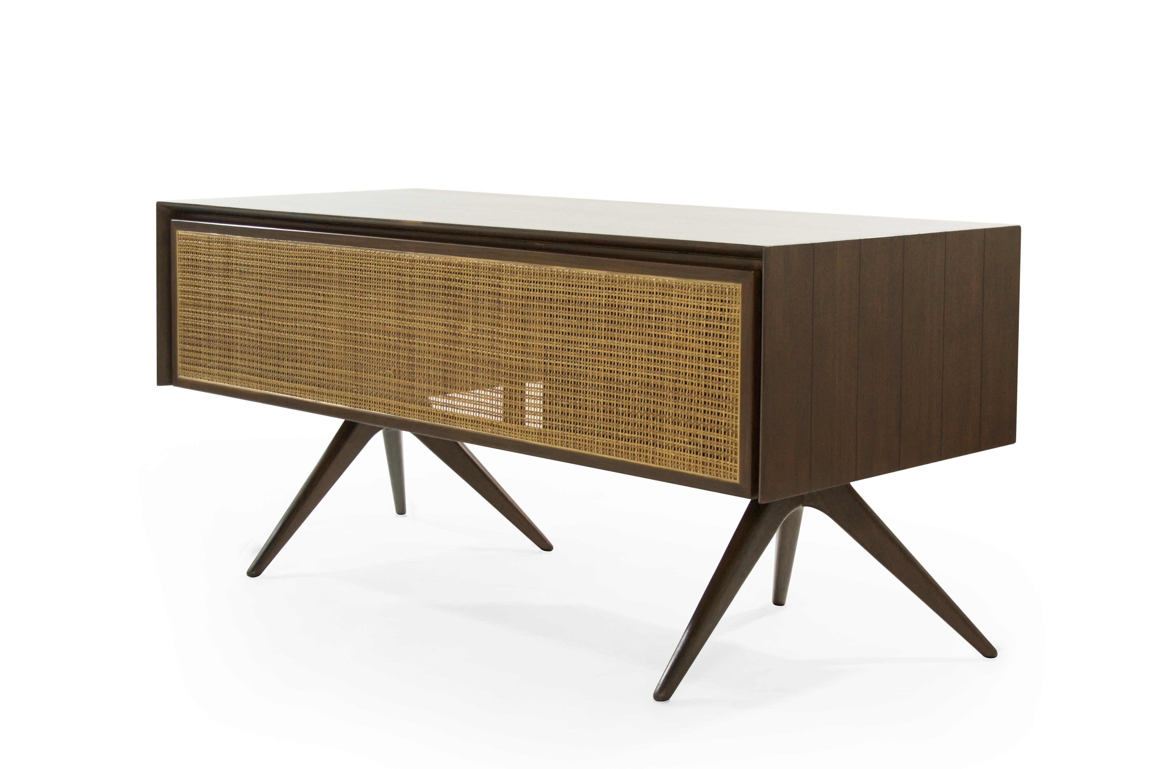 Impressive and rare walnut desk designed by Vladimir Kagan for Grosfeld House, NY, circa 1950s.

Walnut case design features ebony stripes, caned back and brass hardware. 

Completely restored to back its original glory, drawers slide smoothly
