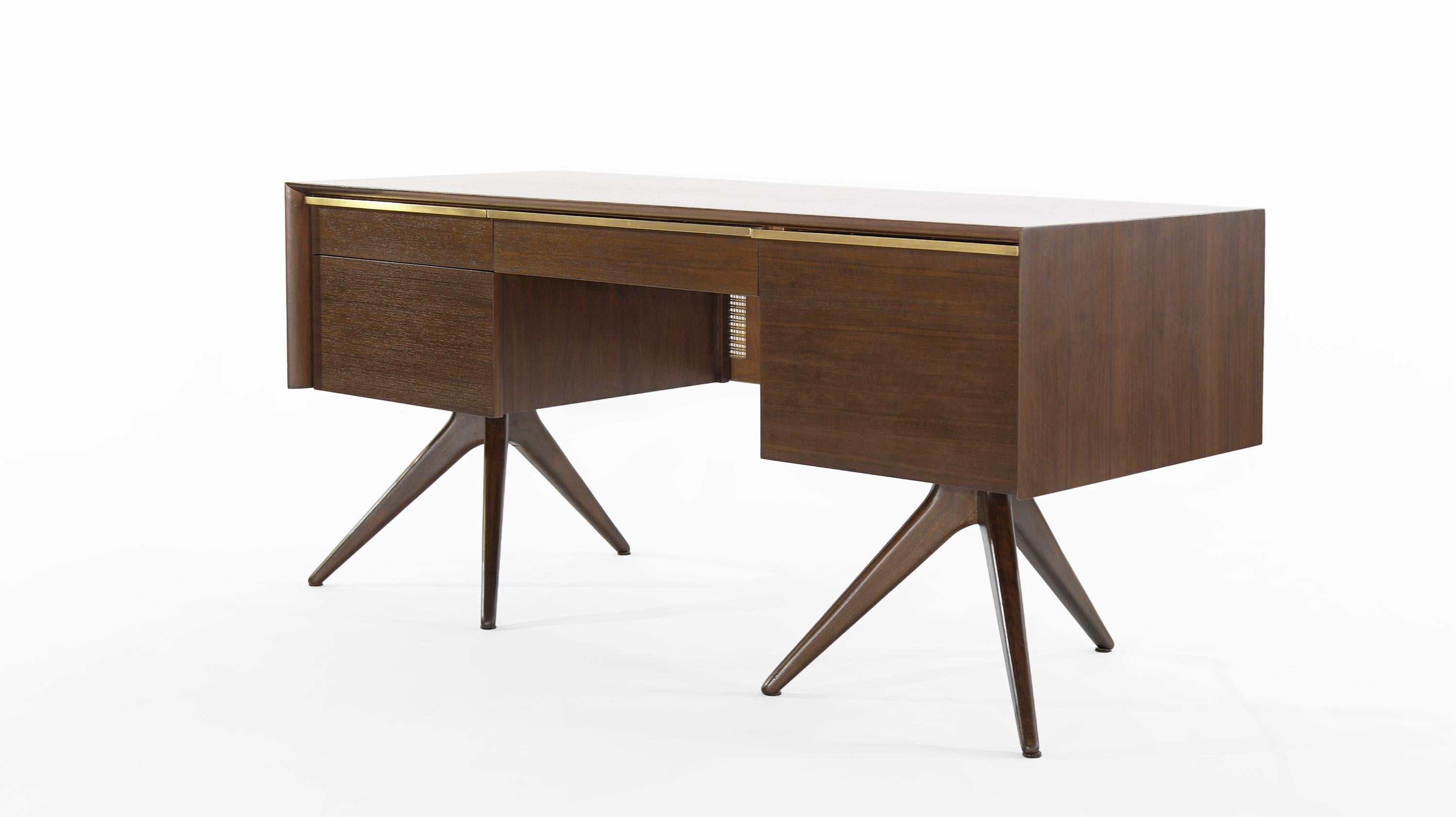 Impressive and rare walnut desk designed by Vladimir Kagan for Grosfeld House, NY, circa 1950s.

Walnut case design features ebony stripes, caned back and brass hardware. 

Completely restored to back its original glory, drawers slide smoothly