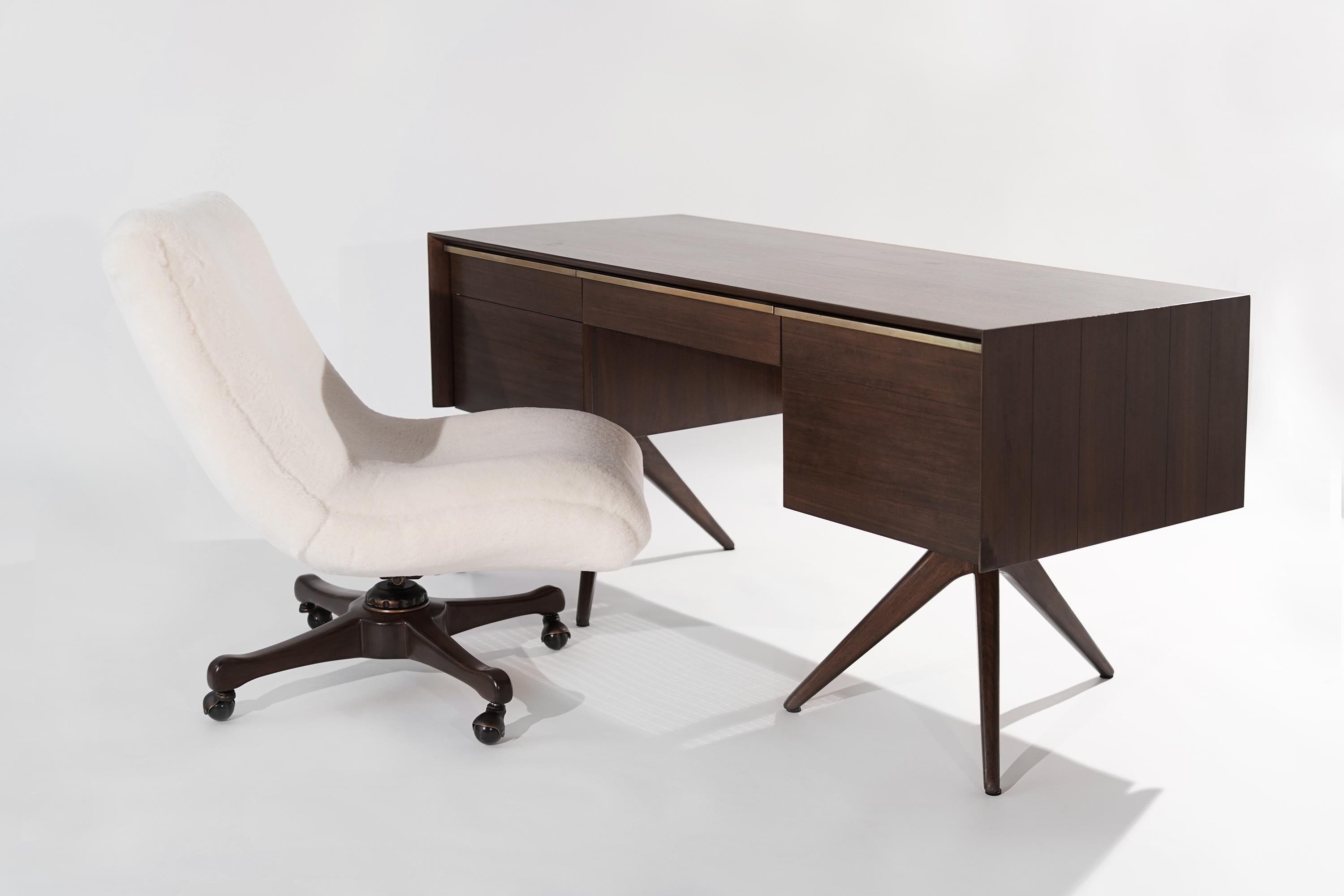 Impressive and rare walnut desk designed by Vladimir Kagan for Grosfeld House, NY, circa 1950s.
Walnut case design features ebony stripes, caned back, and brass hardware. 

Completely restored to back its original integrity, drawers slide