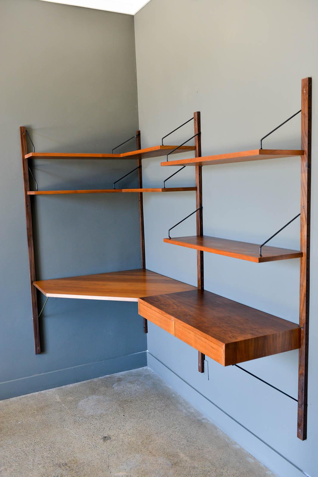 Rare walnut Poul Cadovius corner wall unit with desk, circa 1965. Beautiful walnut shelves and corner desk 2 bay unit in very good original condition. Wall unit includes all pieces shown here, two small corner shelves, one large corner desk, one two
