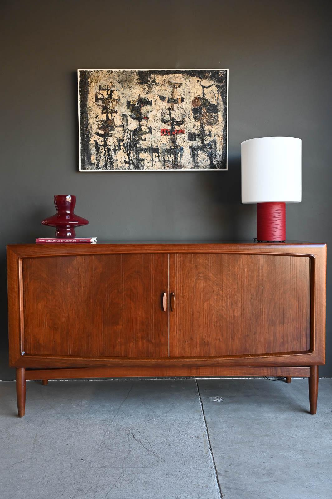 Rare Walnut Tambour Door Credenza by Kurt Ostervig, ca. 1960.  A very scarce walnut tambour door credenza with sculpted pulls and frame by Kurt Ostervig, Denmark.  This beautiful credenza is made from solid walnut (legs and sculpted carved inner