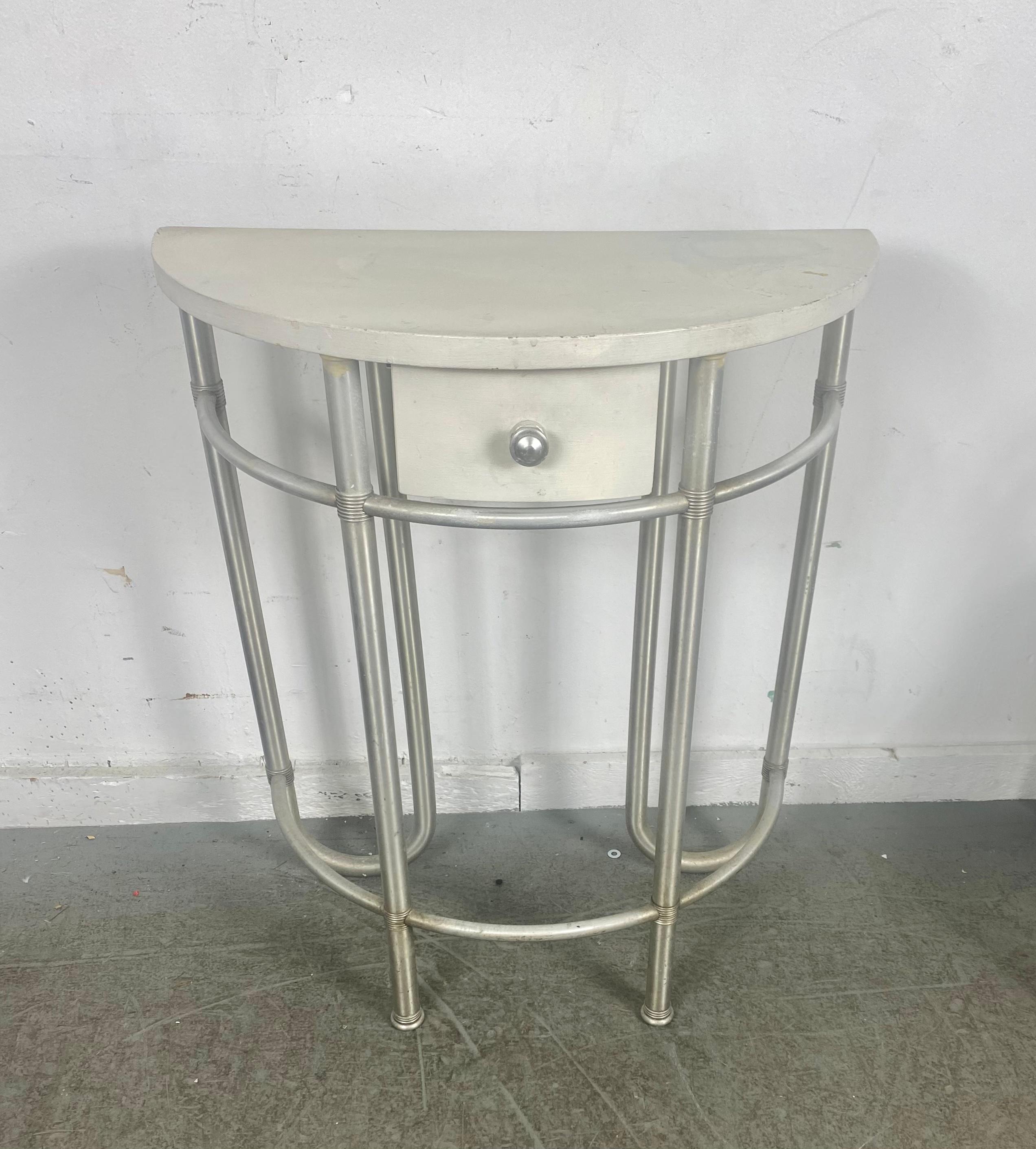 Extremely rare demilune console table designed by Warren McArthur. Amazing design, proportion, table has been re-painted (at some point) Retains remnants of original label, Also original pale yellow color under top. Aluminum frame in nice original