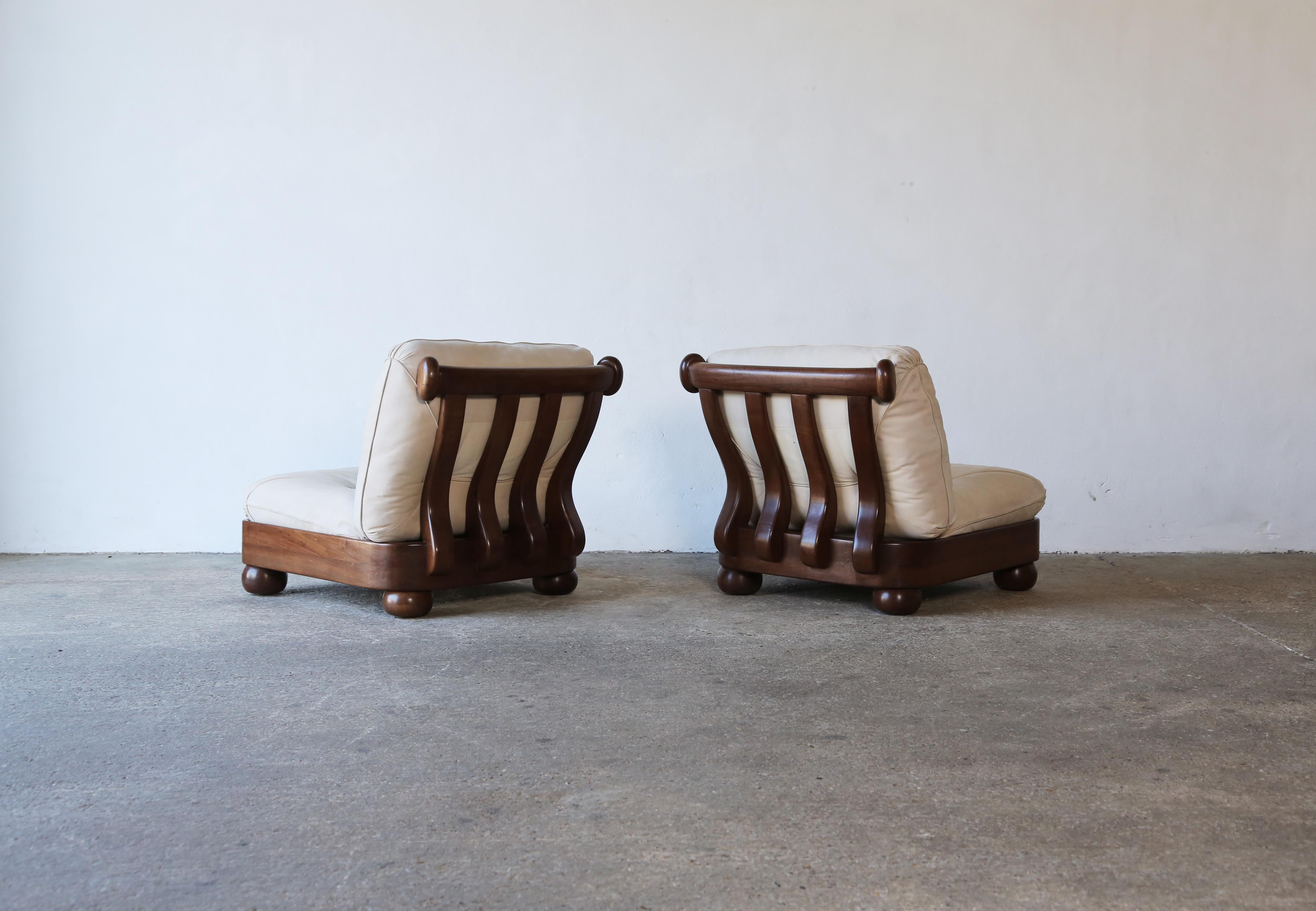 A pair of wavy back lounge chairs, Italy, 1970s. The wooden frames are in original condition, structurally sound, with some signs of use and age. New fabric is recommended on the loose seat and back cushions. Fast shipping worldwide.
  

