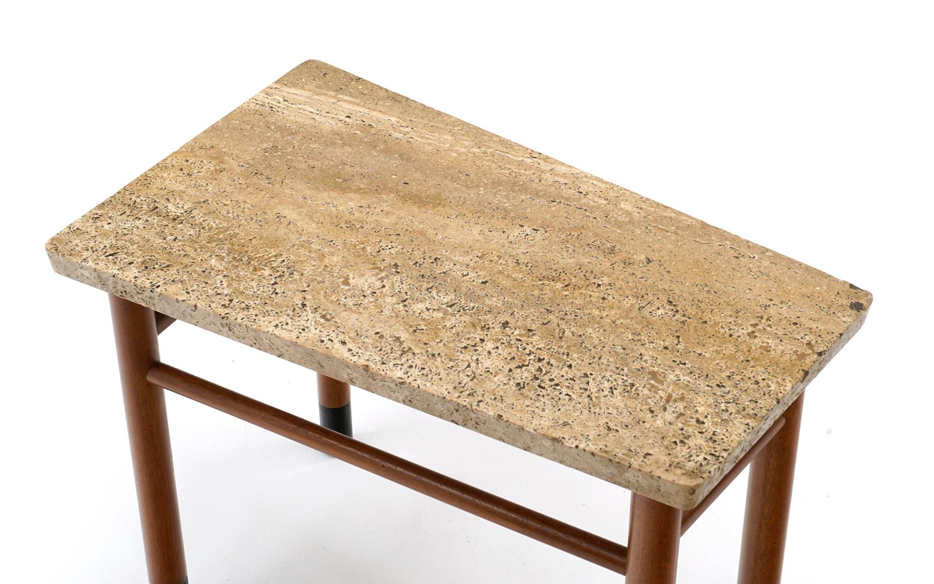 Unique asymmetrical wedge shape side / end table with original Italian travertine top, mahogany legs with black leather wrapped feet. Super rare, early table. Signed with the green Dunbar metal tag.