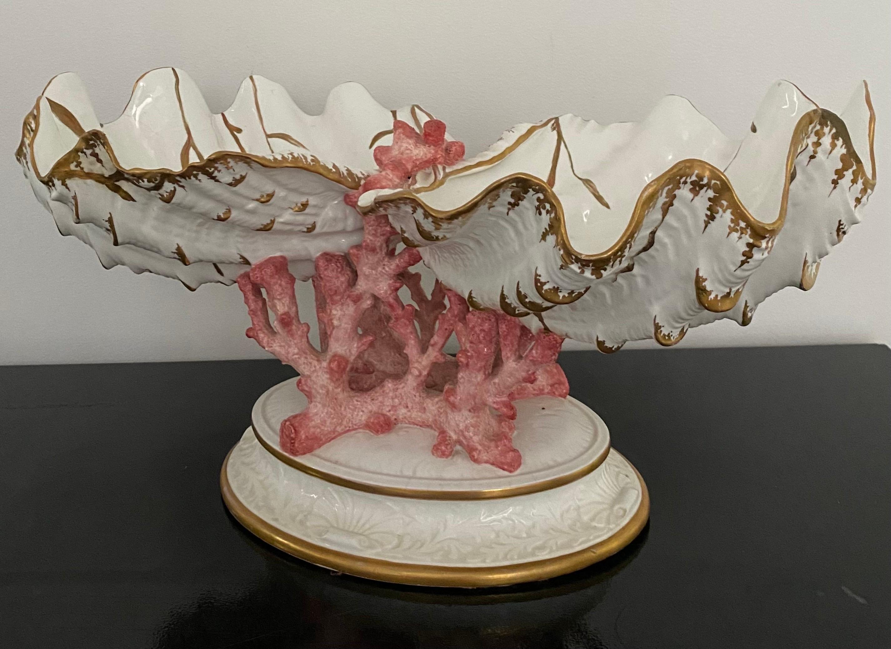 Spectacular Hollywood Regency Wedgwood bone China coral and shell centerpiece, England, early 20th century. Two large hand painted gilt decorated clam shells rest atop sculptural red coral mounted on a stepped oval base. 

This unique majolica