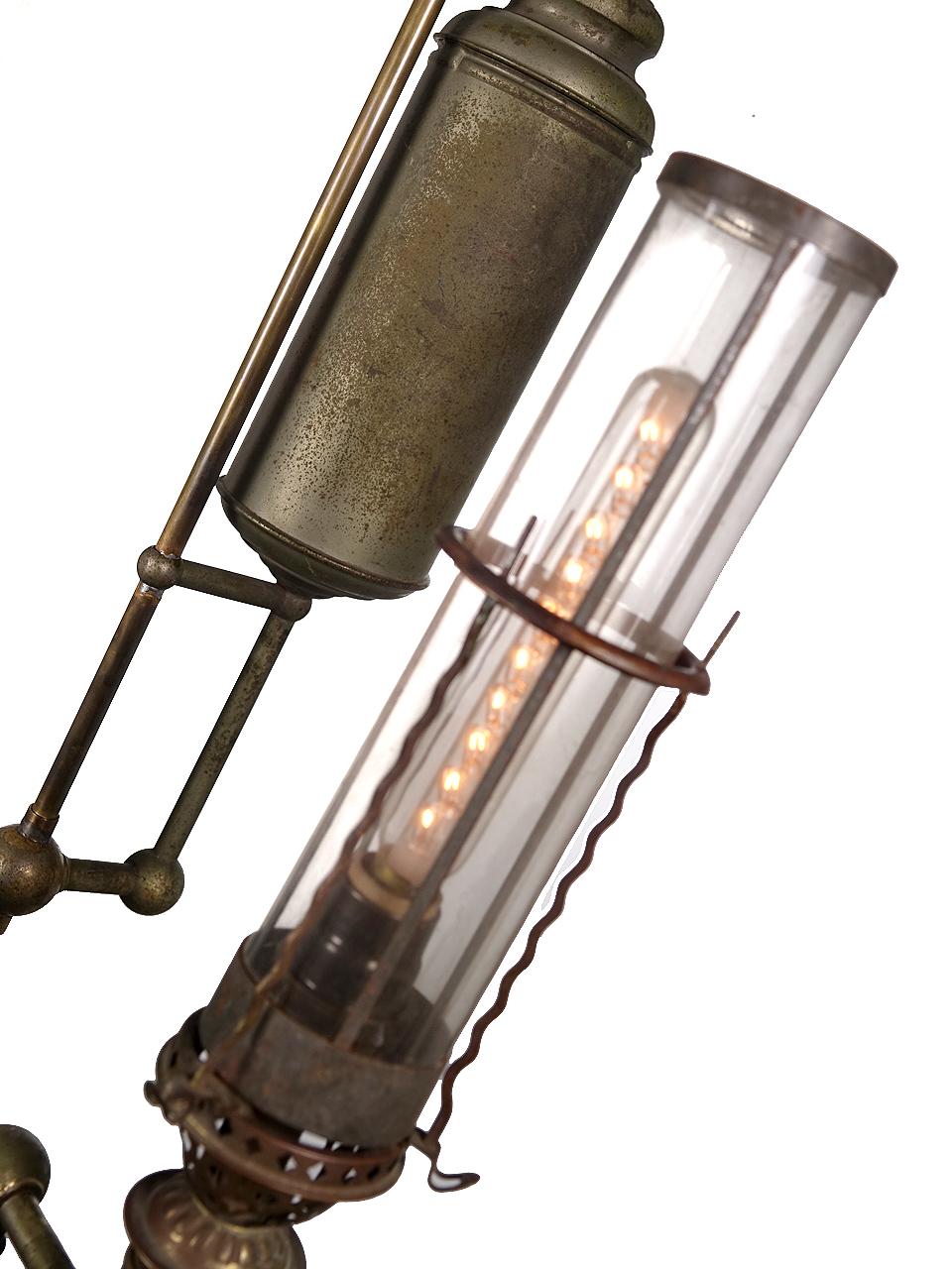 This is a large and dramatic nickel-plated lamp. It's very unusual and not the type of lamp you will find electrified. It's only 8 inches deep but has a 21 inch spread. The 2 original tubular shades are real Mica. Its a unique and very unusual
