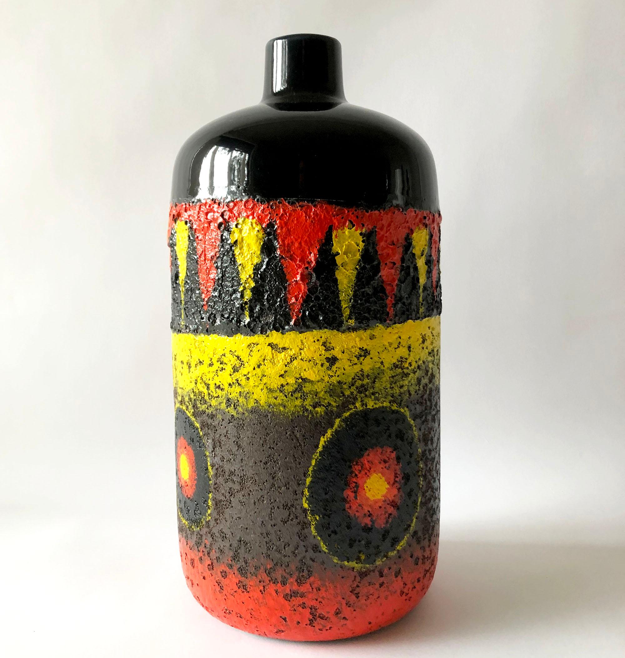 Colorful vase in striking contrasts of red, yellow and black. Vase measures 15.5