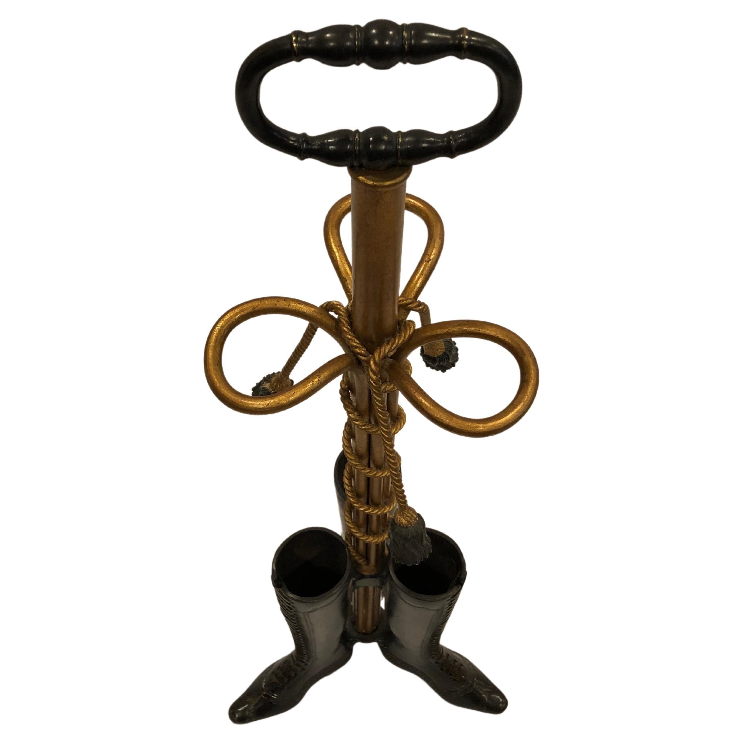 Incredible and whimsical umbrella stand that's a work of art having blackened bronze base in the form of 3 high topped laced ladies boots with the open tops meant for umbrellas or canes. The gilt metal central column is embellished with a pretty