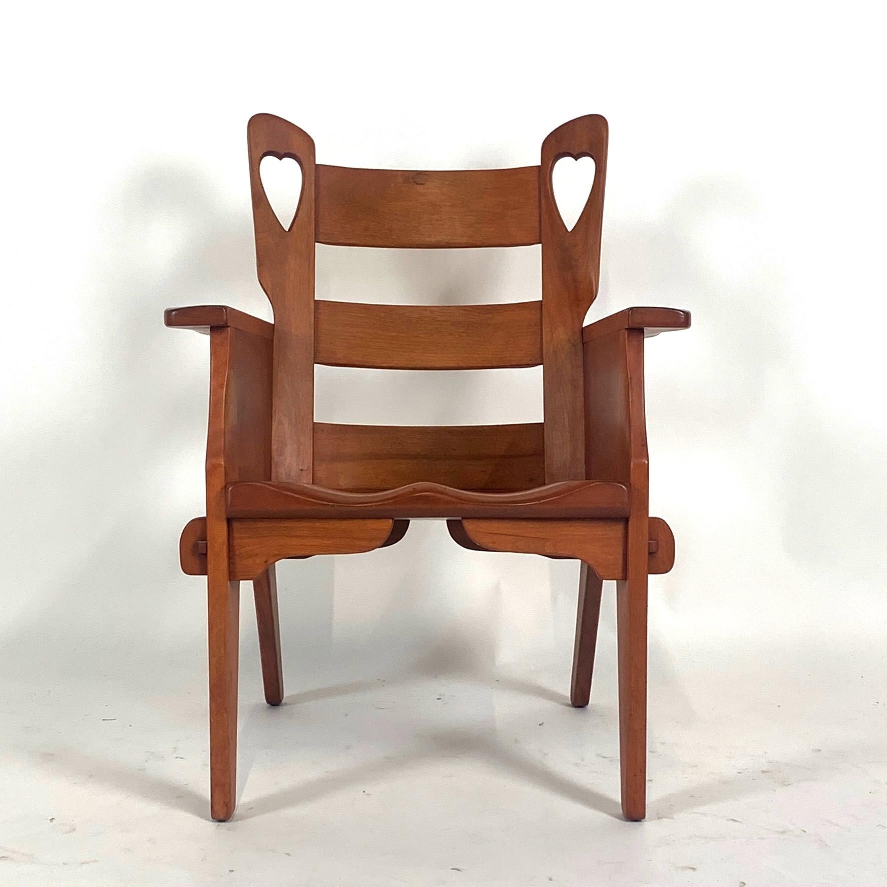 Excellent condition well documented Cushman chair with heart cutout, carved seat, and wedged mortise and Tenon construction. This is an excellent example of a rare Cushman chair.