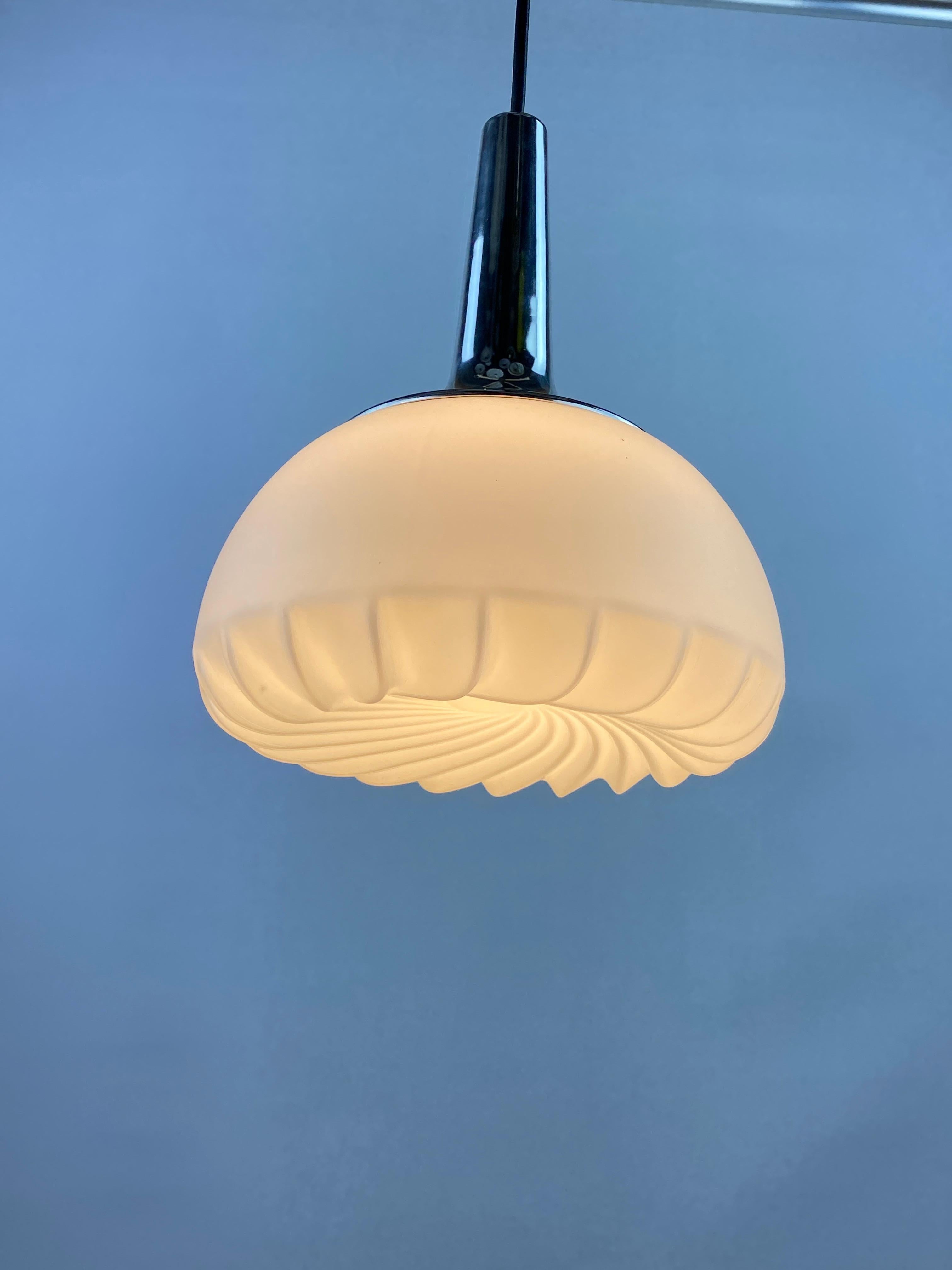 Rare frosted glass and chrome pendant light by Peill and Putzler from the 1970's. Provides very warm diffuse light. Has a funky but elegant swirl on the bottom of the lamp.


DIMENSIONS
Height: 31cm
Diameter: 24cm
Cord length: 40cm

PRODUCT