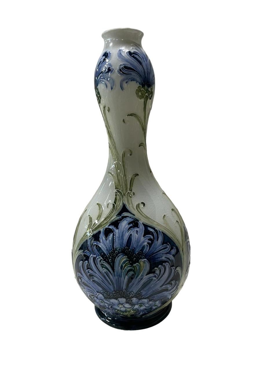 Moorcroft for James MacIntyre & Co., Florian Ware 'Cornflower' vase of double gourd form, decorated in blue and green on ivory ground, printed factory mark in brown, script signature in green.
Minor restoration
height 8.7 in — 22 cm
Good