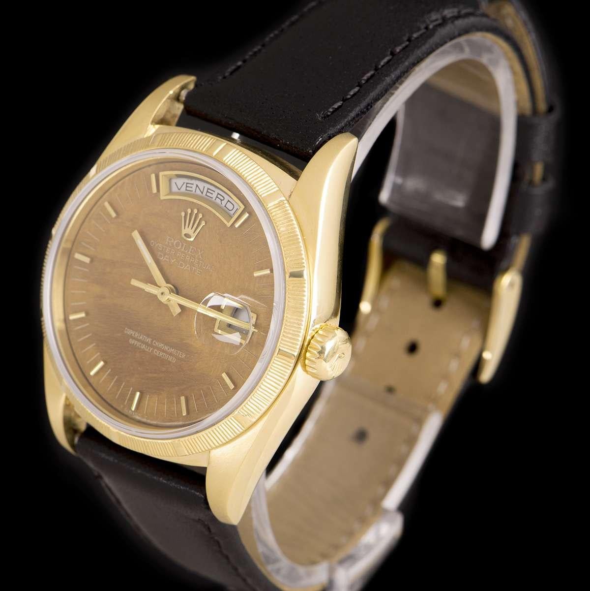 An 18k Yellow Gold Oyster Perpetual Day-Date Gents Wristwatch, rare wood dial with applied hour markers, day aperture at 12 0'clock, date aperture at 3 0'clock, a fixed 18k yellow gold engine turned bezel, a brand new black leather strap (not by