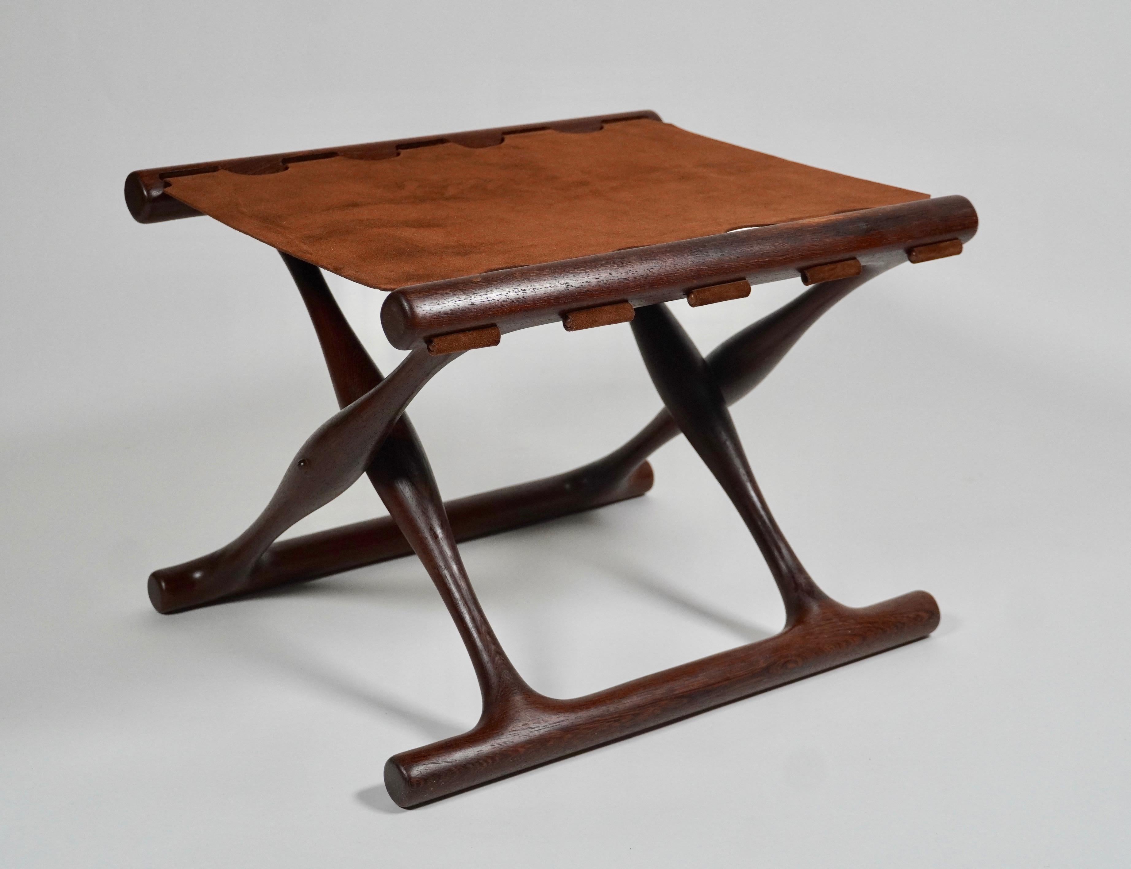 Folding Poul Hundevad, PH43 stool 'Goldhøj', Denmark, 1960s.
This is a rare model that is made of solid African wenge and high quality cinnamon colored suede leather. The inspiration for this design was drawn from oldest preserved piece of