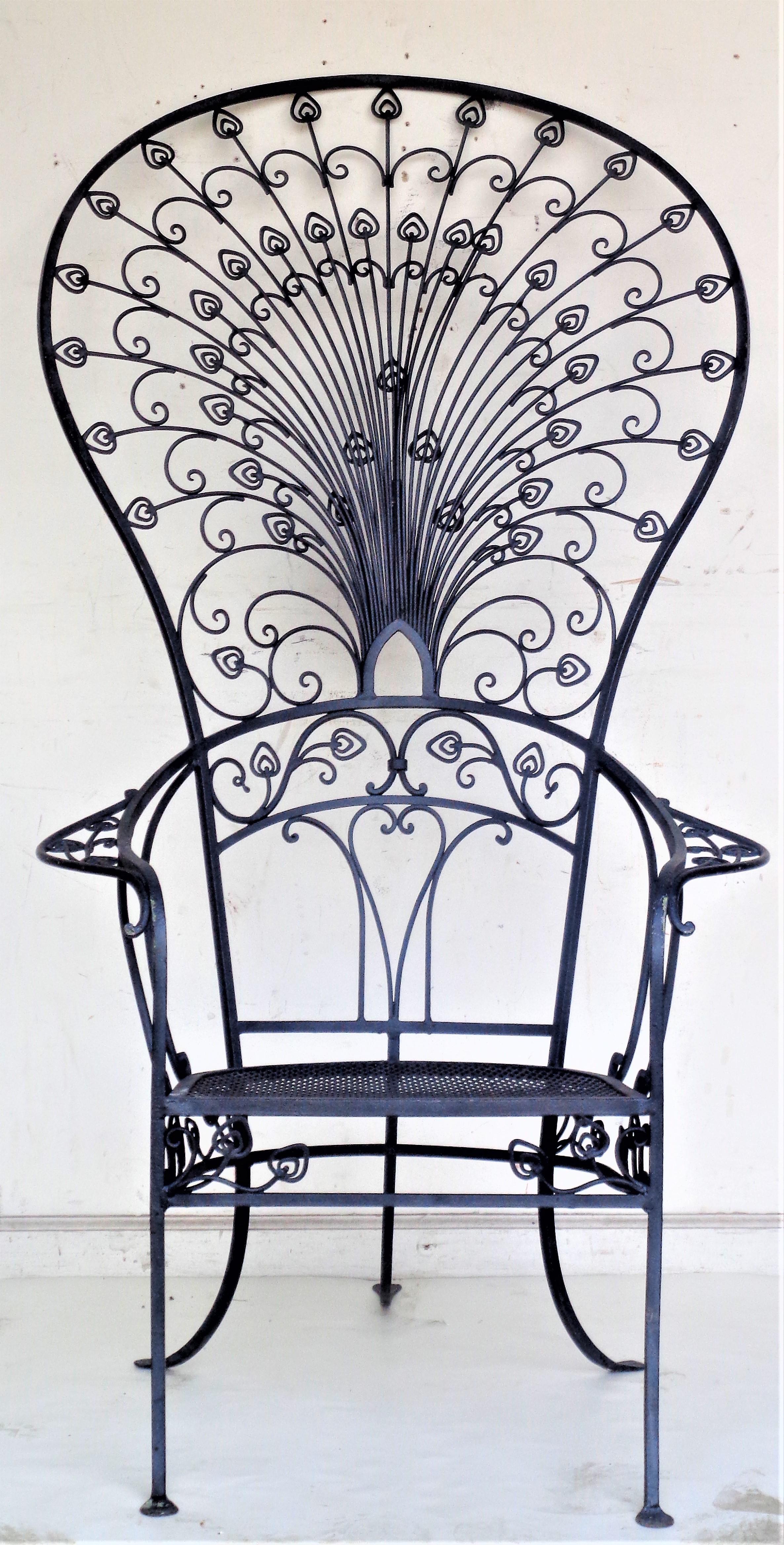 Two exceptionally rare antique wrought iron peacock chairs ( a near pair - the difference being in lower part of back rests and design of mesh seats ) Both chairs in beautifully aged old flat black painted surface. Chair on the left in primary image