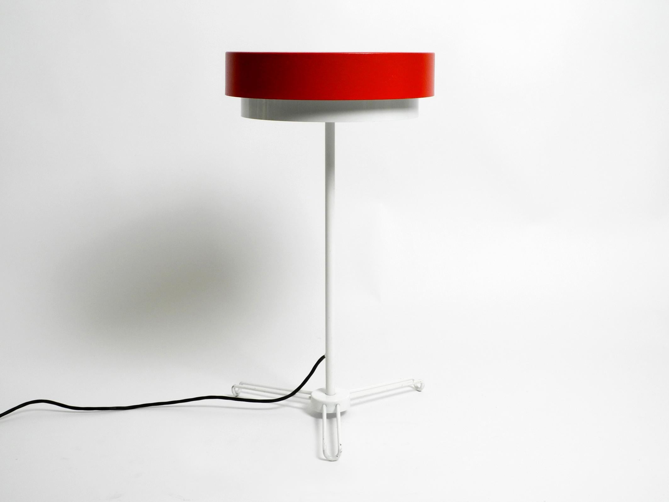 Very rare mid-century metal tripod patio floor lamp made of metal.
Beautiful minimalist German design.
The red and white varnishing is original. 100% original condition. Fully functional. One E27 original ceramic socket. Makes a very nice soft