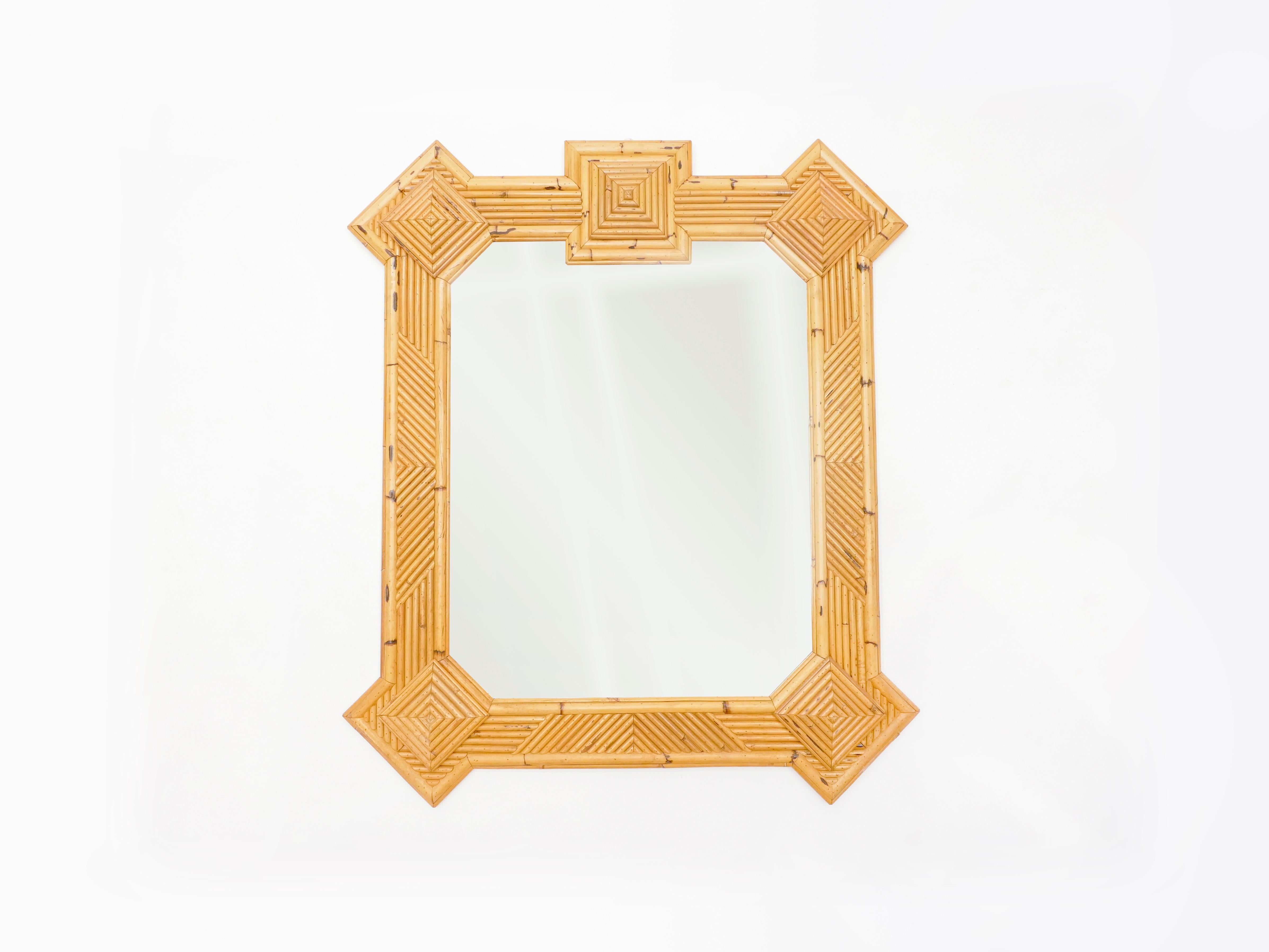 This extra large mirror was designed by Maurizio Mariani for Vivai Del Sud in Roma in the early 1970s. It mixes rattan, bamboo and cane from India, making this decorative frame entirely handmade quite unique and beautiful. Vivai Del Sud was a