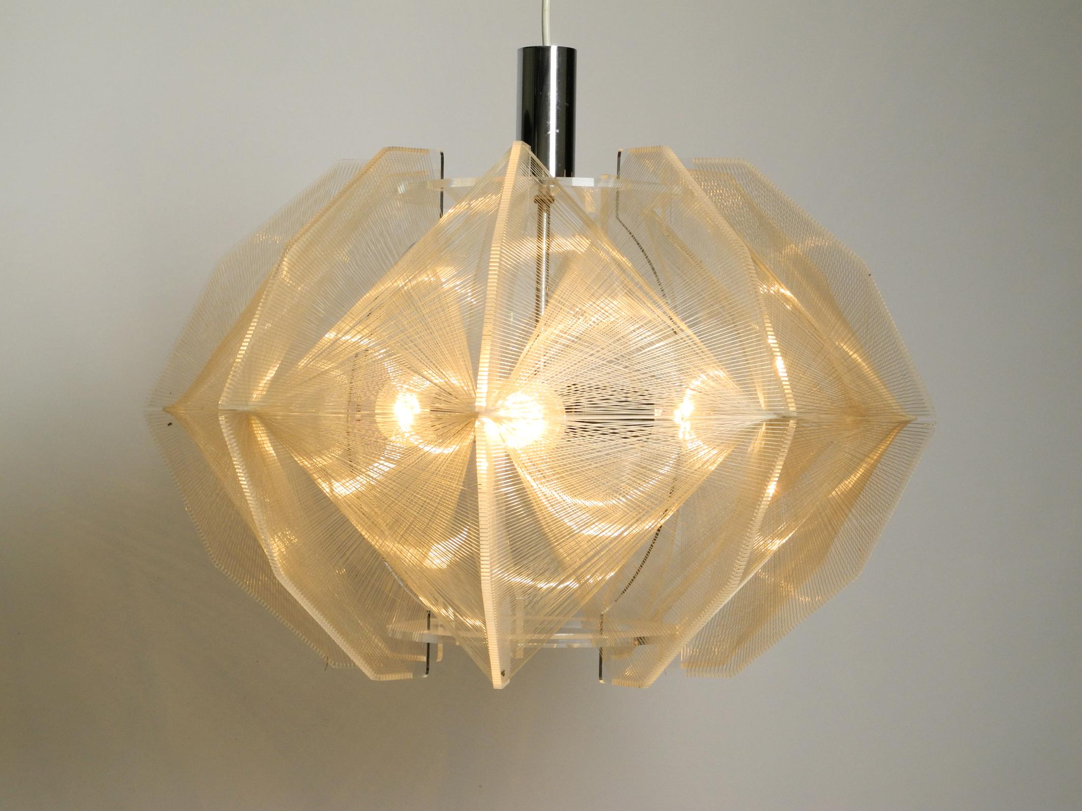 Beautiful XXL rare large 1970's nylon thread plexiglass pendant lamp by Paul Secon. Manufactured by Sompex.
Great light with interesting light reflections. Chrome metal attachment.
Three E27 original sockets. Enough light even for large