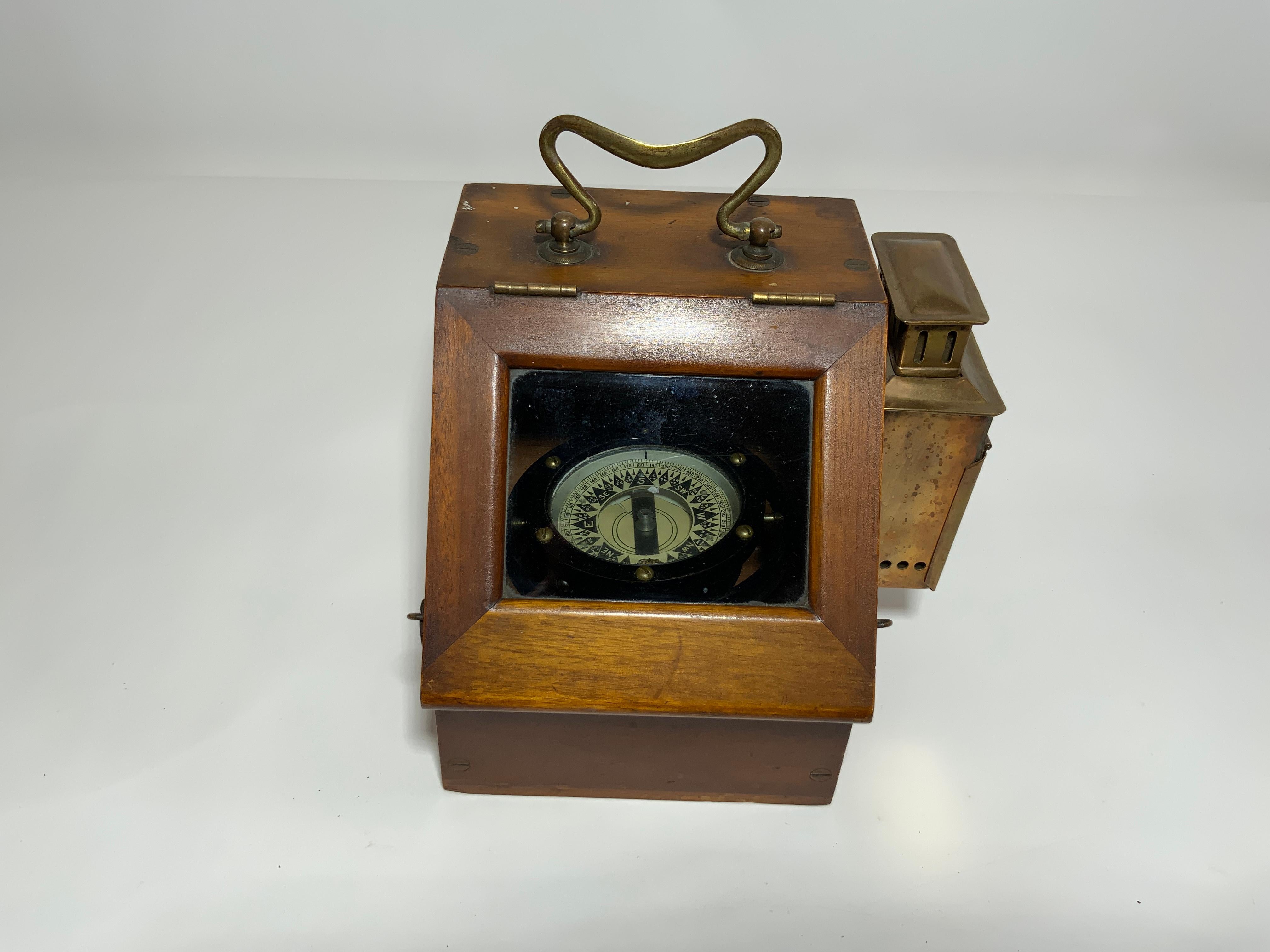 Solid brass gimballed boat compass fitted to a hinge front wood binnacle. Brasses include carry handle, side light, brass hooks, etc. Circa 1920.

Overall Dimensions: 7