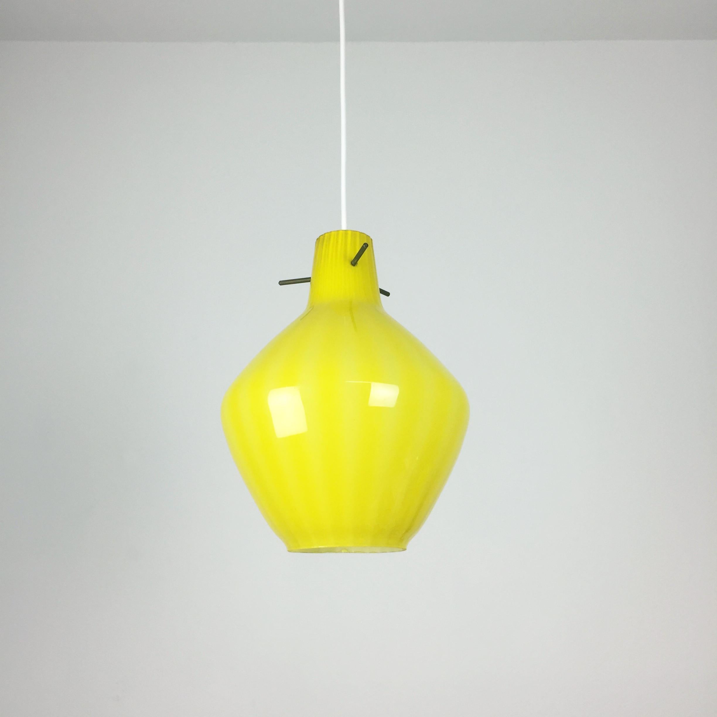 Article: Hanging light


Origin: Italy


Age: 1960s 


Description: 

This fantastic yellow drop hanging lights was designed and produced in 1960s in Italy. The shade is made of high quality italian handblown glass. Due to the shade, the light