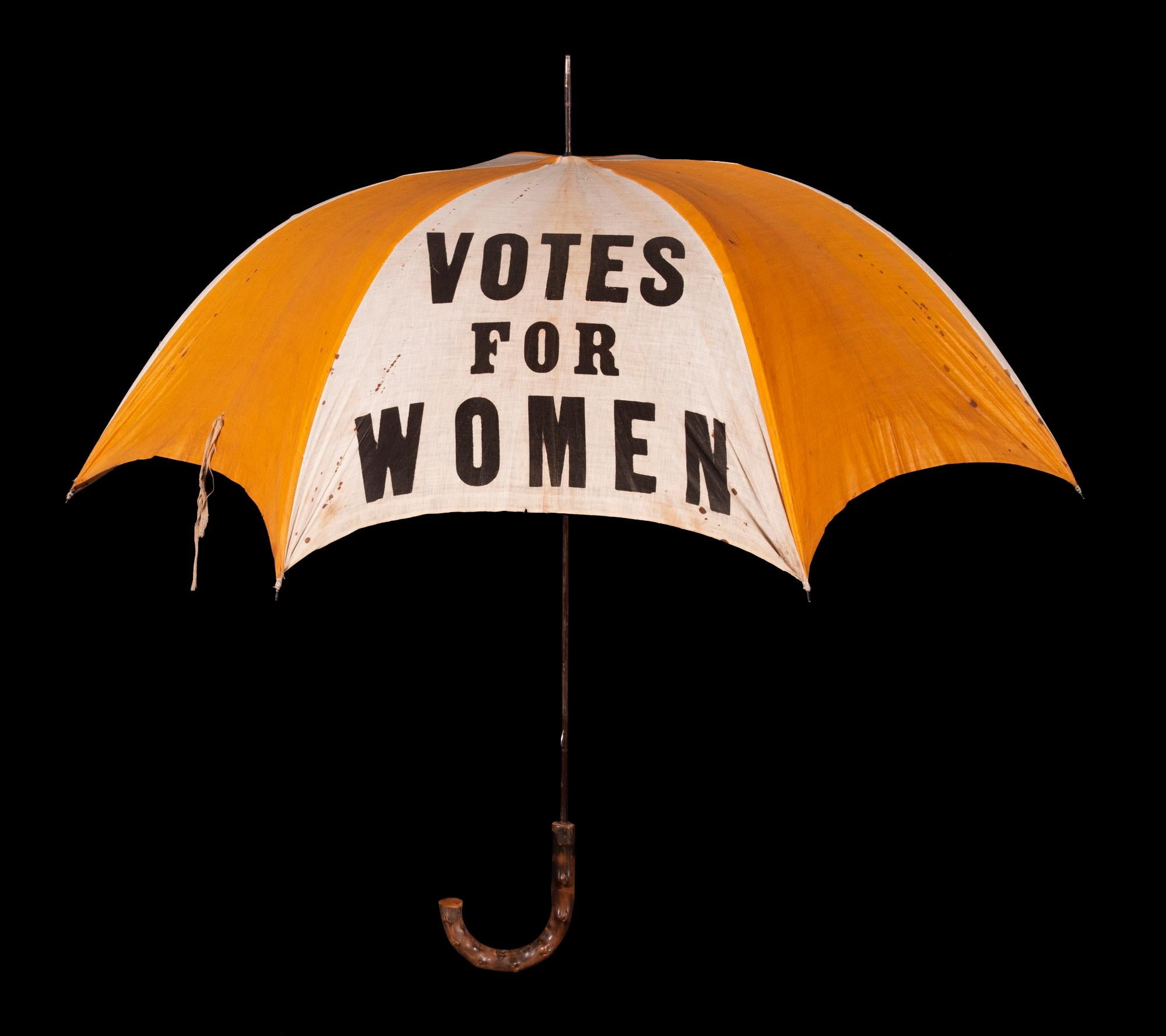 EXTRAORDINARILY RARE, YELLOW & WHITE, SUFFRAGE PARASOL / UMBRELLA, WITH “VOTES FOR WOMEN” TEXT, DISTRIBUTED BY THE NATIONAL AMERICAN WOMEN’S SUFFRAGE ASSOCIATION UNDER ANNA HOWARD SHAW’S LEADERSHIP [HEADQUARTERED IN NEW YORK], CIRCA 1913-1915:

In