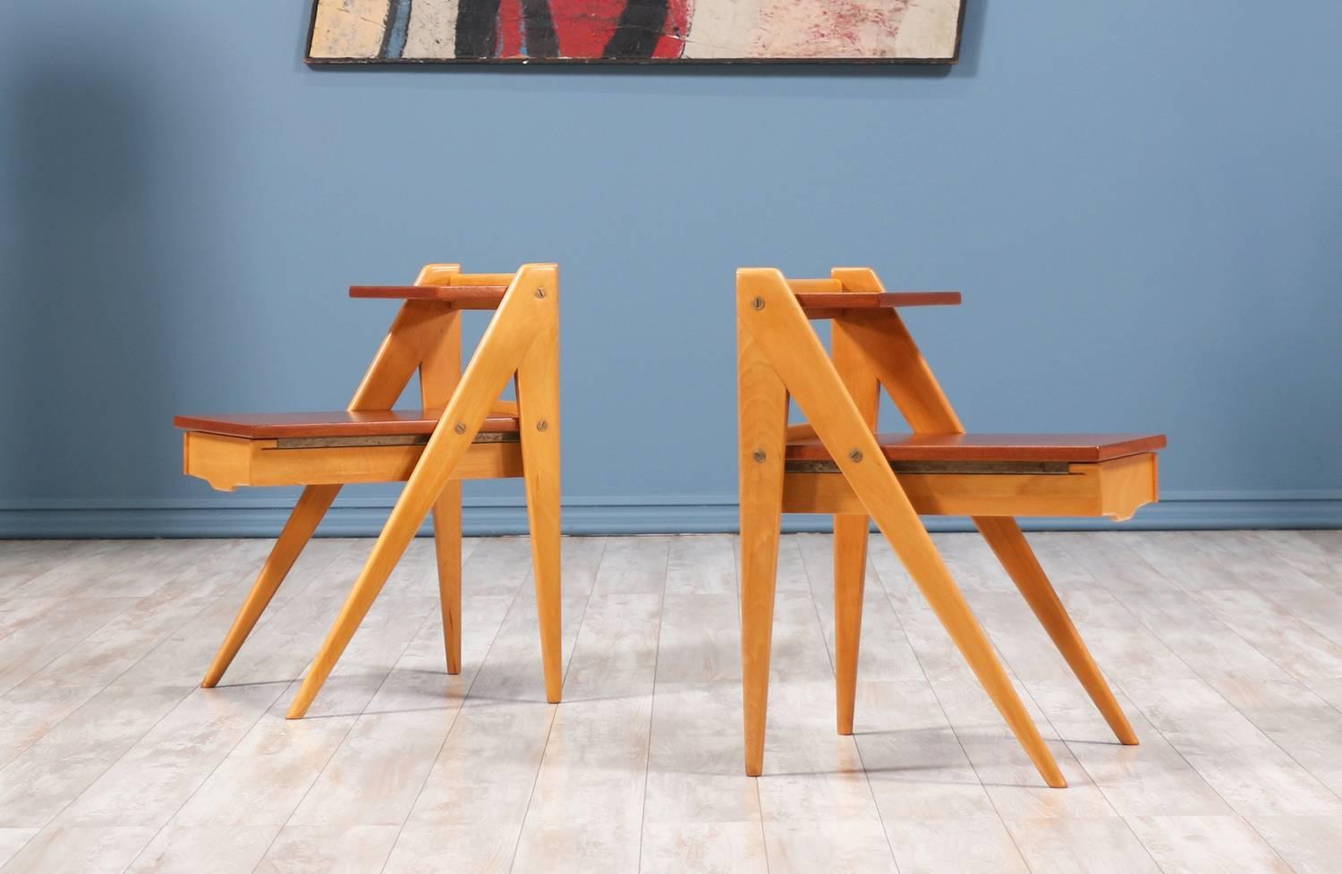 A pair of side tables designed and manufactured by Yngve Ekström in Sweden circa 1950’s. This exceptional pair of side tables features a beechwood frame with scissor-like legs and contrasting teak tops. Each table has brass hardware and a shallow