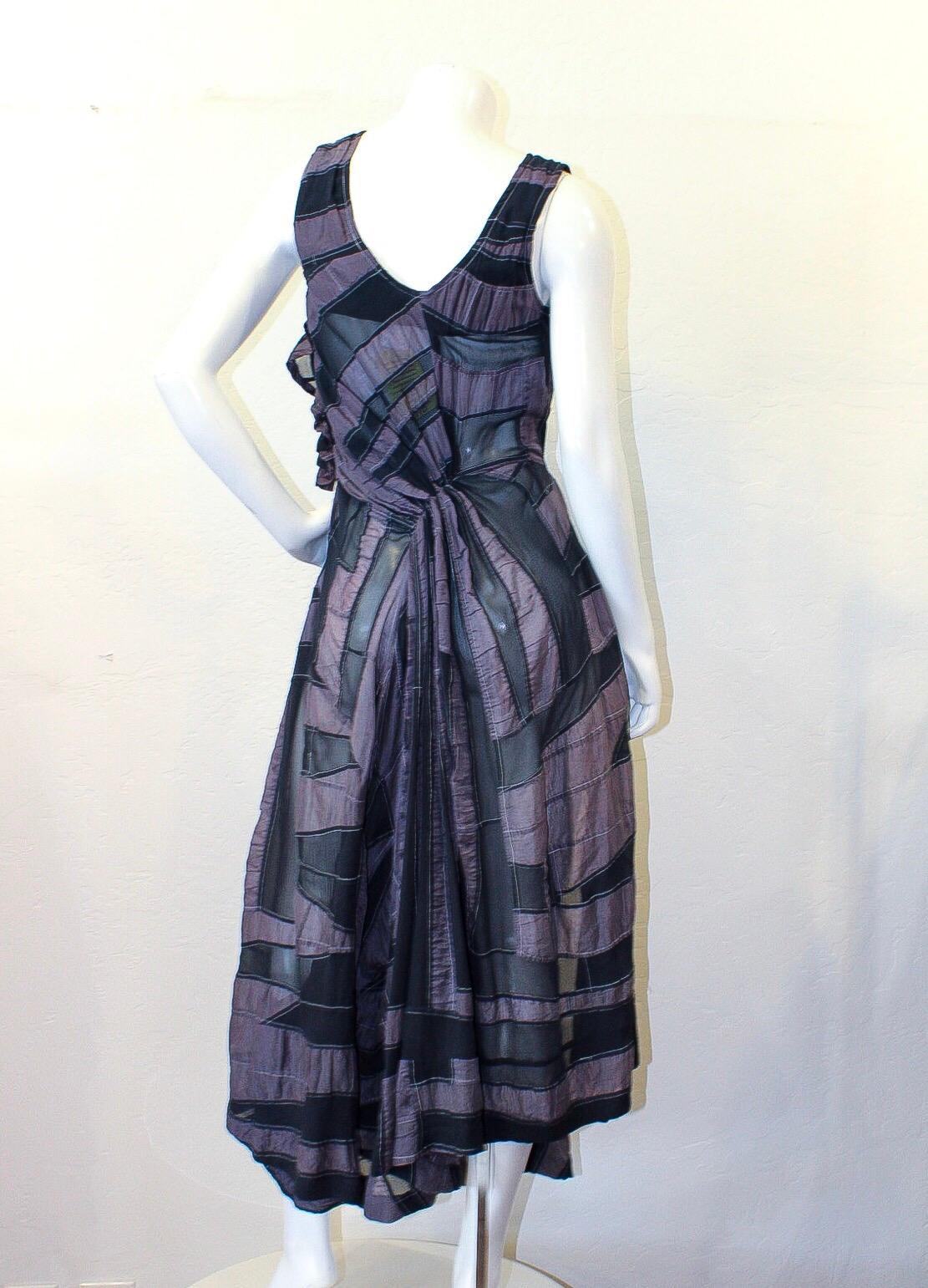 Make the ultimate vintage statement with this amazing Yohji Yamamoto dress! Circa 1980s, this rare sheer maxi dress features a black and deep lavender asymmetrical striped pattern and cinched/gathered stitching at the waist, hip, and back creating a