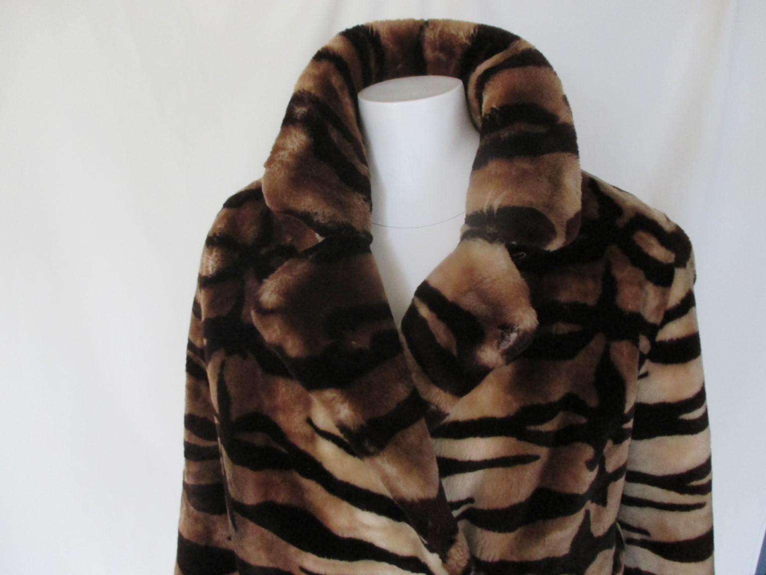 This Unique vintage coat from 1980's is made of sheared sheepskin/mouton/beaver fur in design tiger print.

We offer more luxury fur items, view our frontstore.

Details:
With 2 side pockets, 2 closing clips and 4 belt loops, no belt included.
Fully