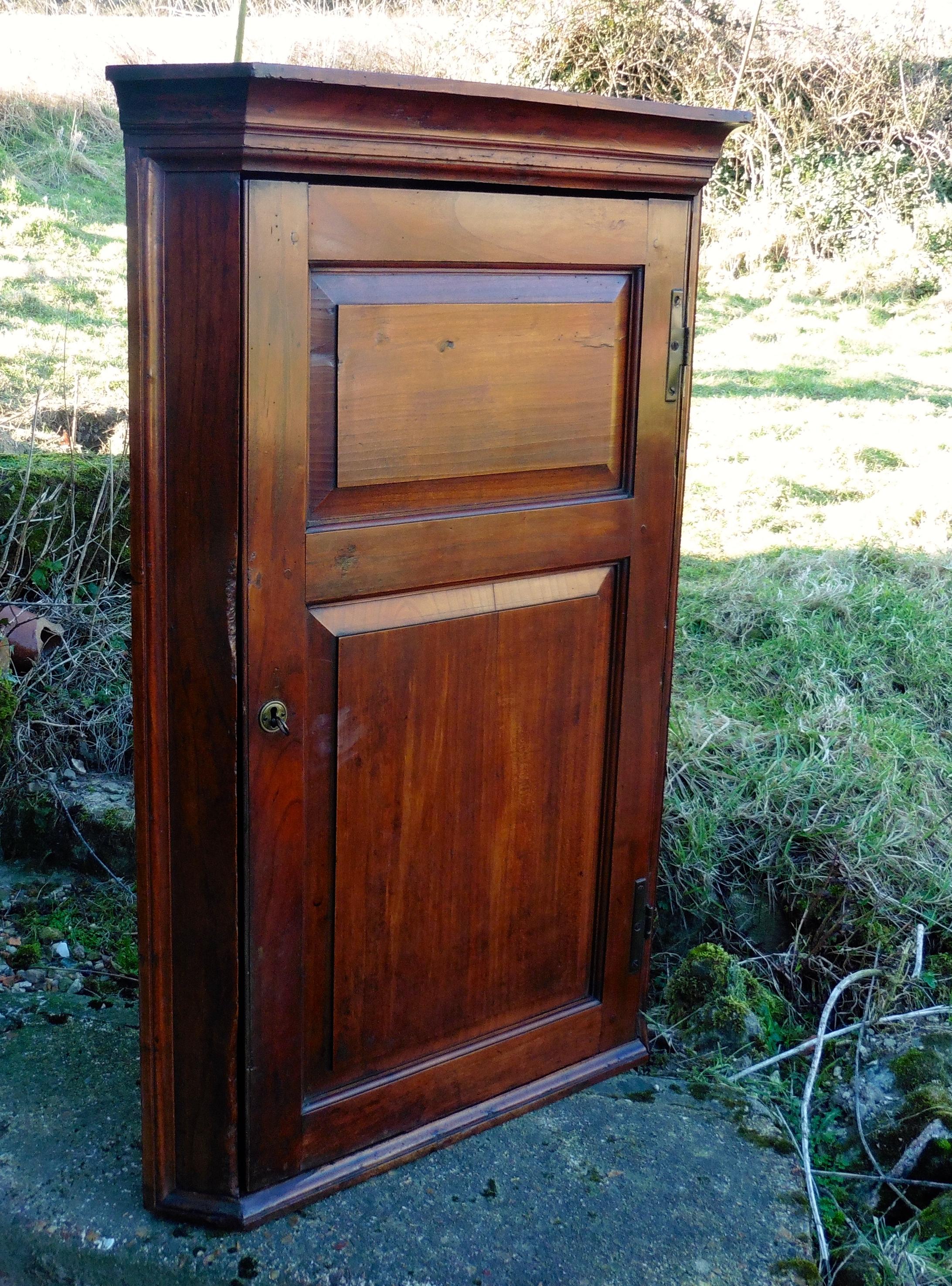 Rare18th Century English Cherry Wood Corner Cupboard

This is a rare piece, a 18th Century Corner Cupboard made in English cherry wood, much darker than the better known continental cherry wood
The cupboard has a 2 panelled doors with blacksmith