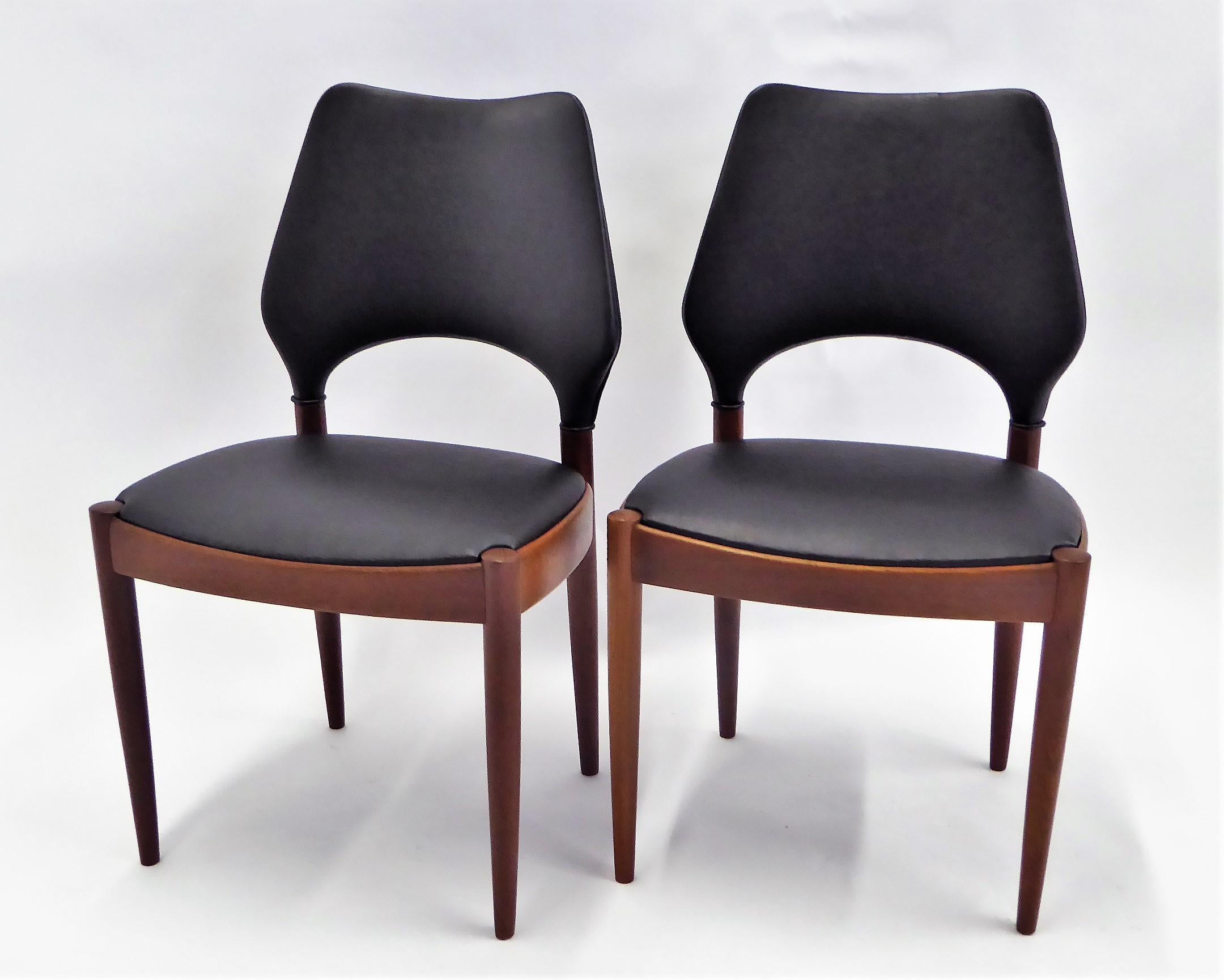REDUCED FROM $1,950...A fine pair and very rarely seen teak side or dining chairs by Arne Hovmand Olsen in 1958 for Mogens Kold Mobilfabrik in Denmark. Beautiful older teak. Re-upholstered in leatherette. The chairs have an exceptionally designed