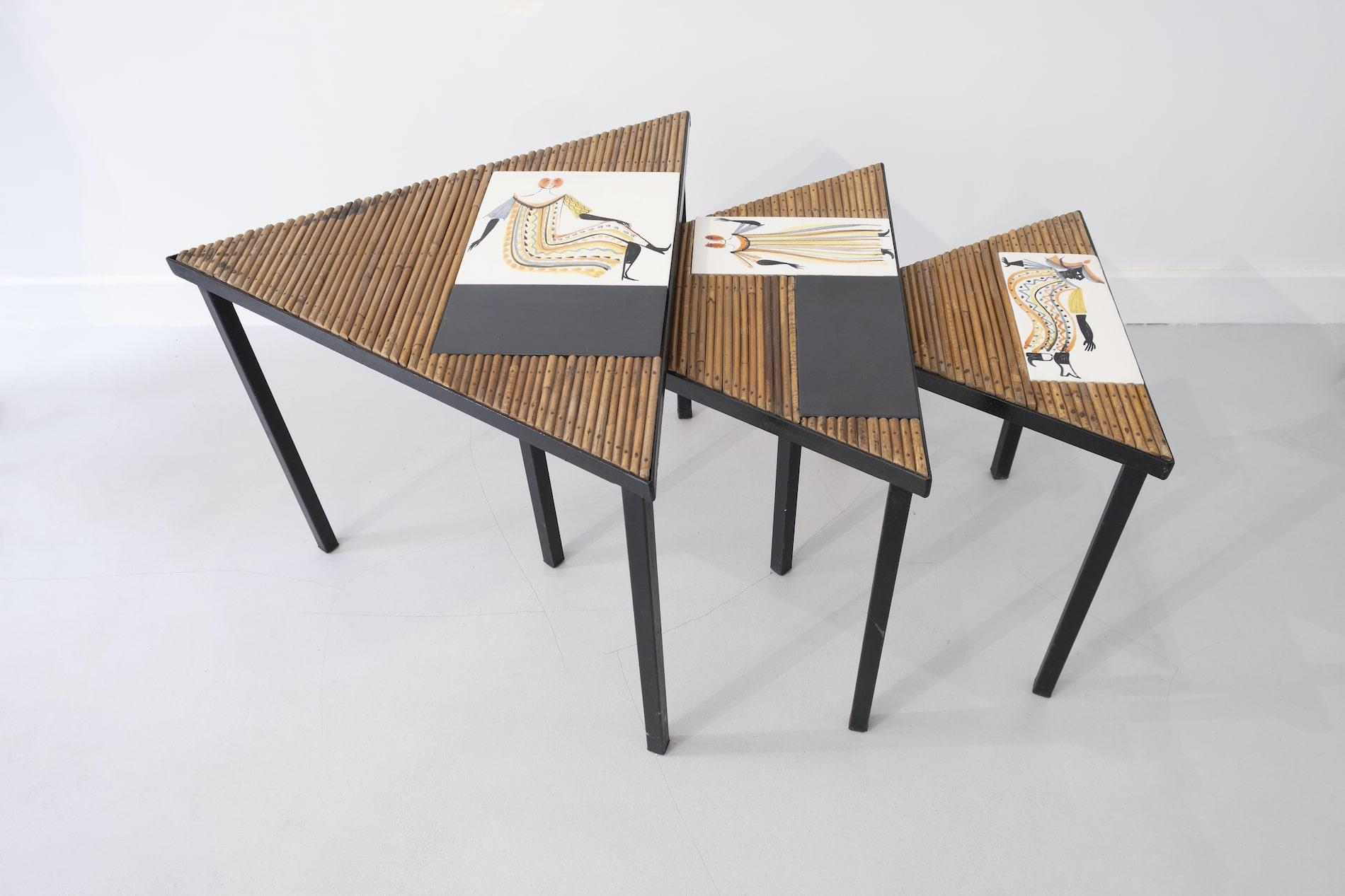 Roger Capron and Audoux-Minet

Rare serie of nesting tables of triangle shapes with tops mixing ceramic tiles and bamboo rods; black painted steel frames

Vallauris, France,  circa 1960
Collectible piece.

The large one :
Length x width : 23.6 x