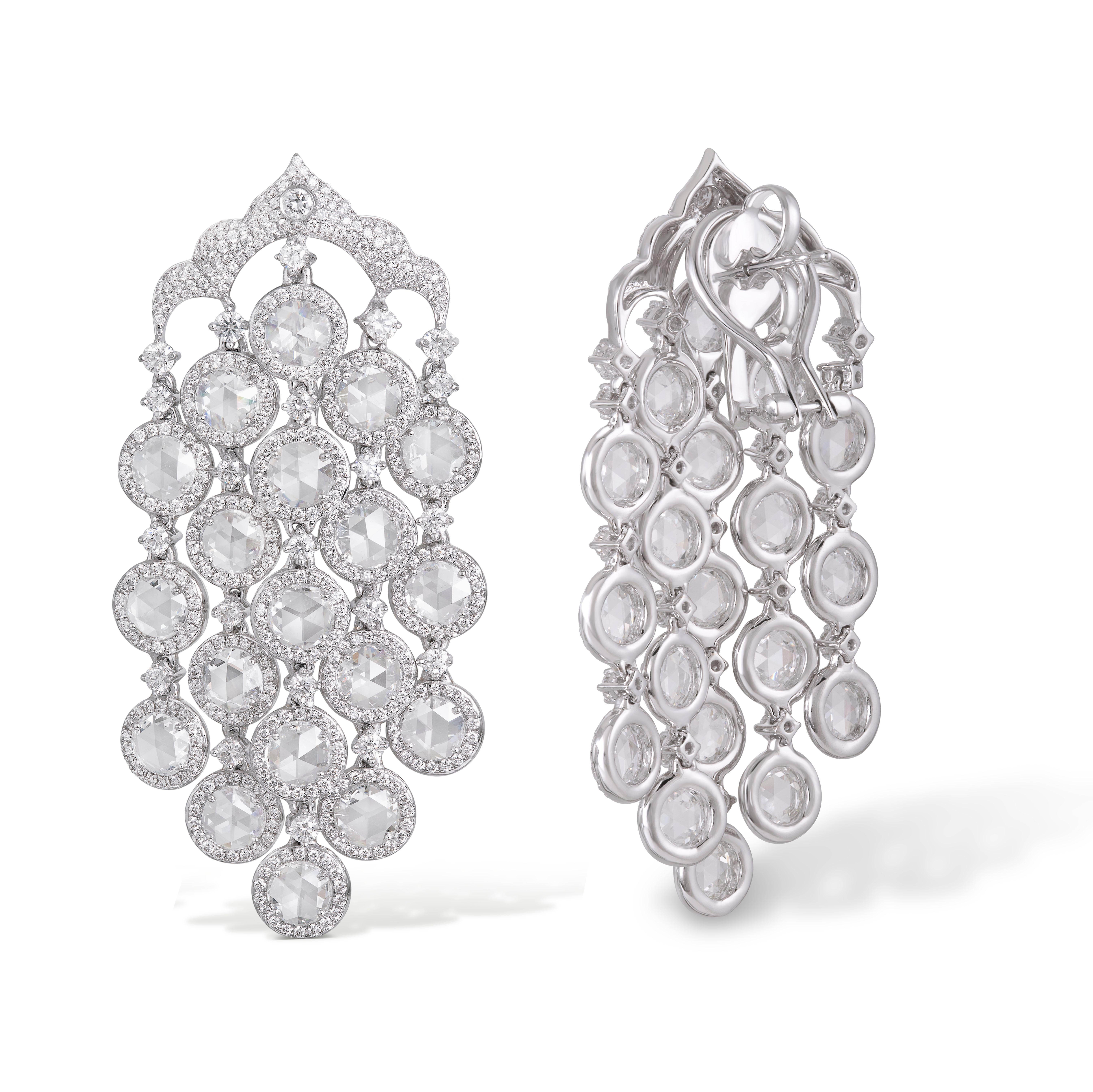 These Rarever earrings take their inspiration from the natural beauty of a waterfall. 38 round rose cut diamonds are set in a draping fashion, surrounded with halos of round brilliant cut diamonds. The subtle movement of the rose-cut diamonds