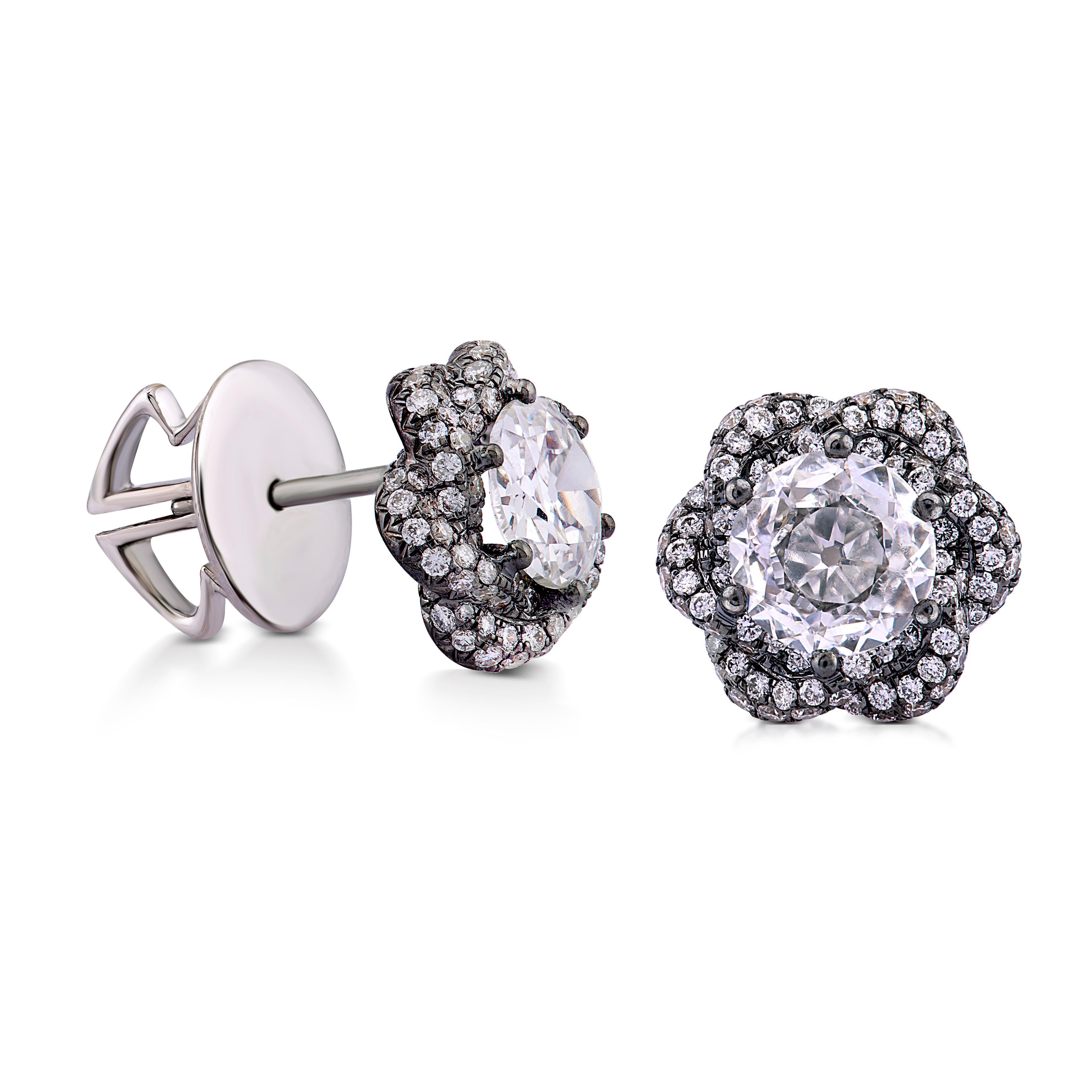 Classic yet modern, these ear studs play with the antique romance of two round old cut diamonds, totalling 1.37cts, showcasing them in a contemporary setting. The black rhodium gives an edginess to these otherwise feminine studs, which are softened