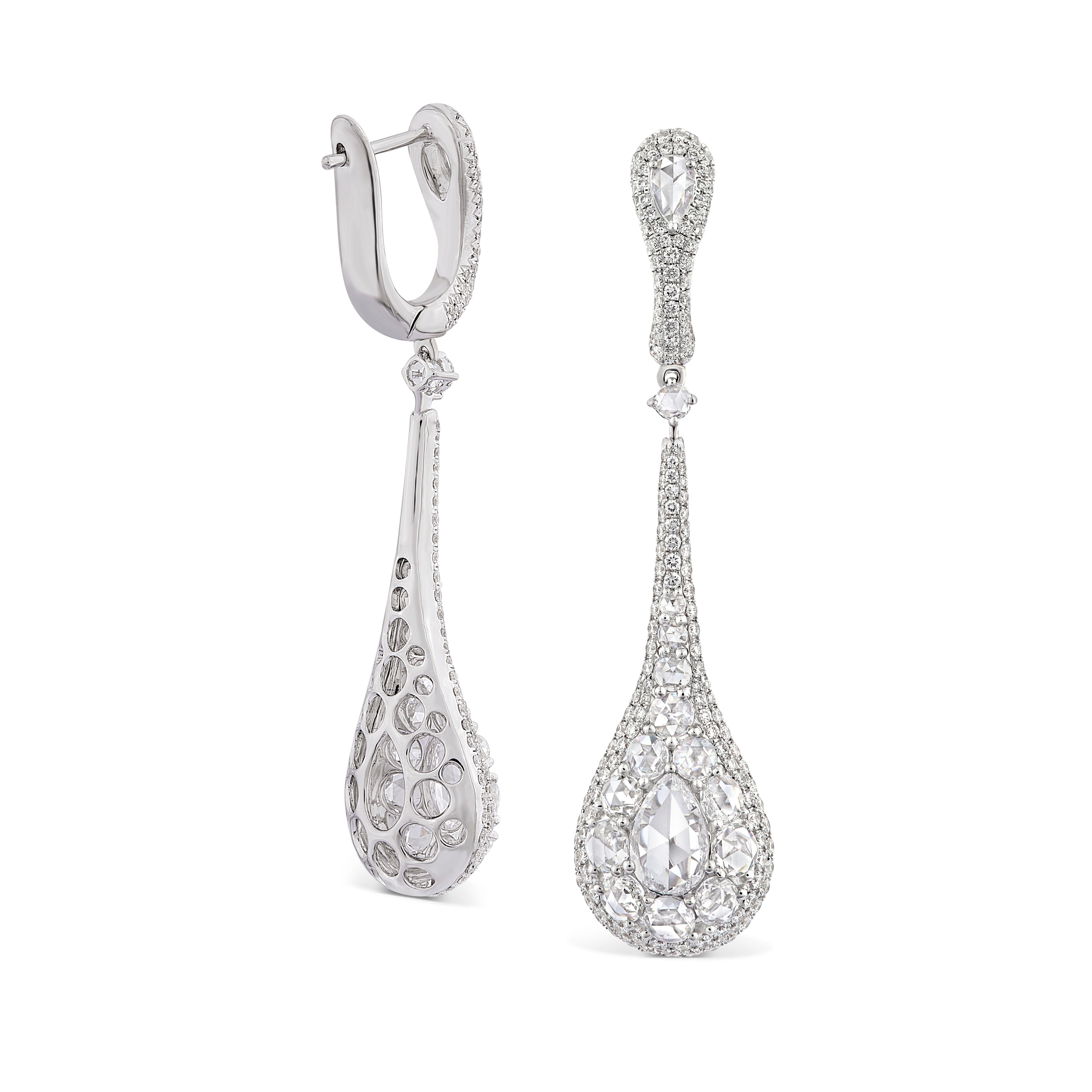 These elegant drop earrings, encrusted with 32 rose-cut diamonds and 336 micro pave set round brilliants, capture the natural symmetry of dewdrops glistening on a winter morning. The central set pear shape diamonds, with a combined weight of