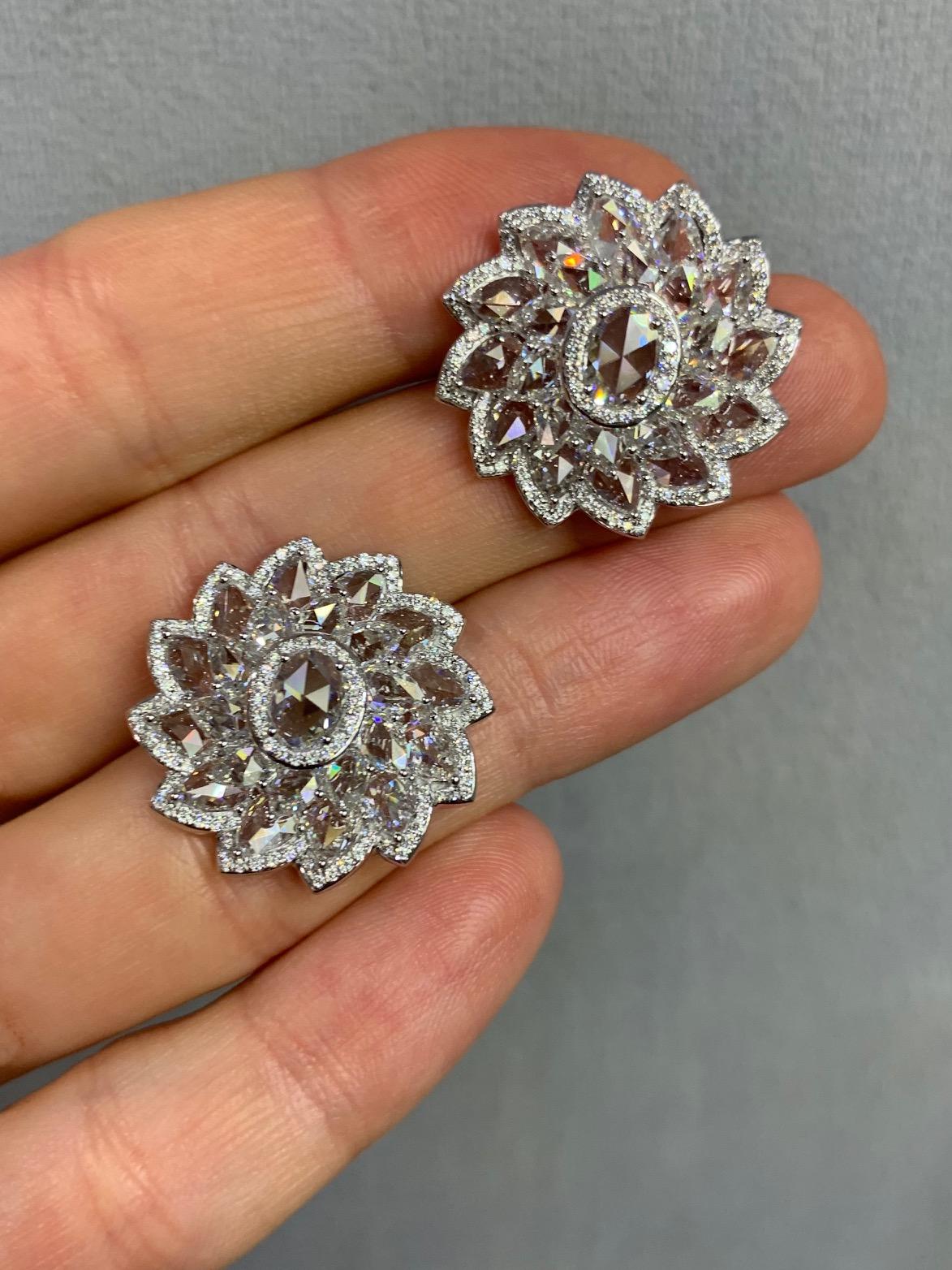 Light dances across the 44 slanting rose-cut pear shape diamond petals of these elegant floral ear studs, that are set to catch the light from every angle. The centres are each set with a 0.30ct oval rose cut diamond. 

Total diamond weight