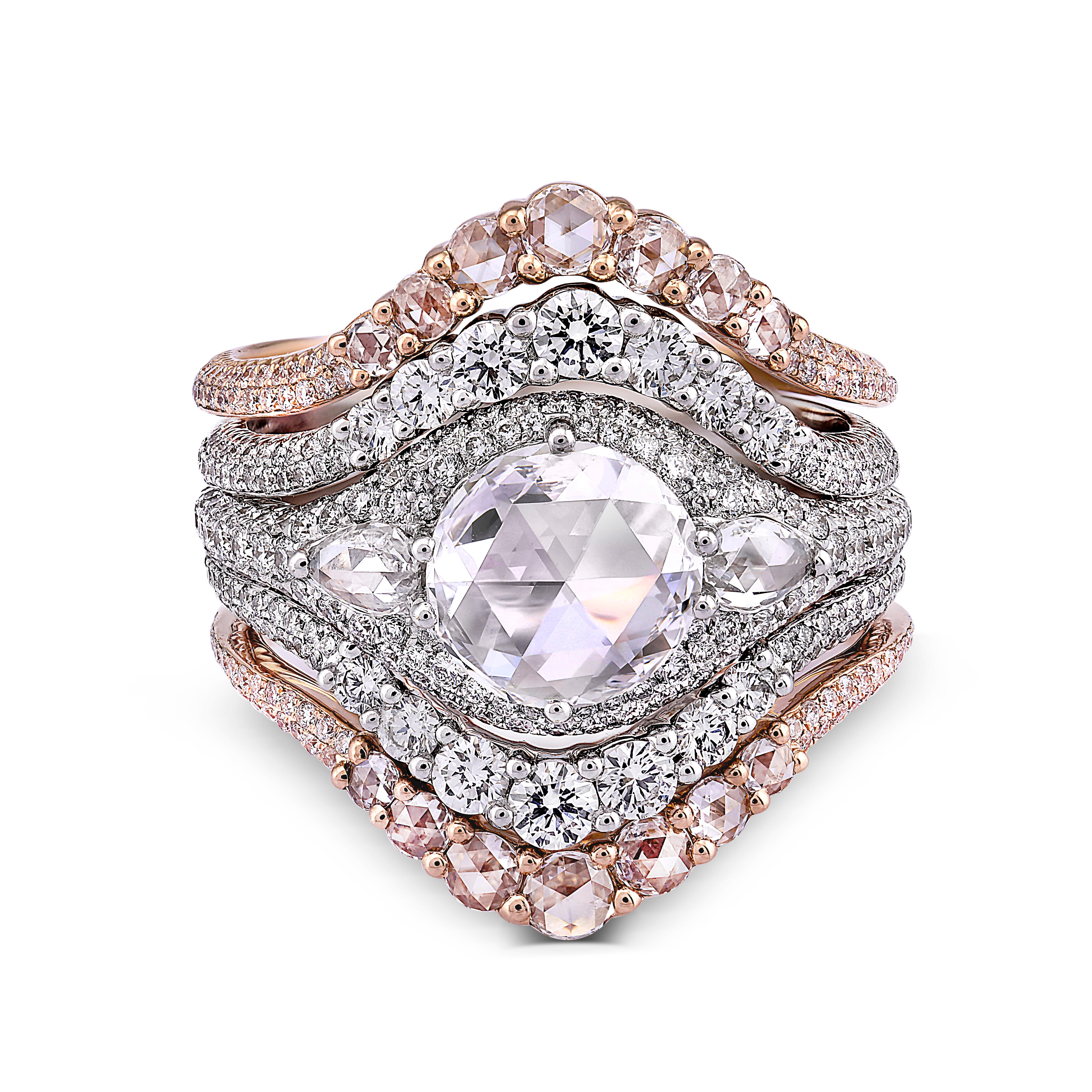 A hypnotic combination of rose and white gold, wed to multitudes of diamonds, give rhythm to this playful design. The central ring is set with a 1.09ct rose cut diamond and finished with 389 pave set diamonds. The outer rose and white gold rings are