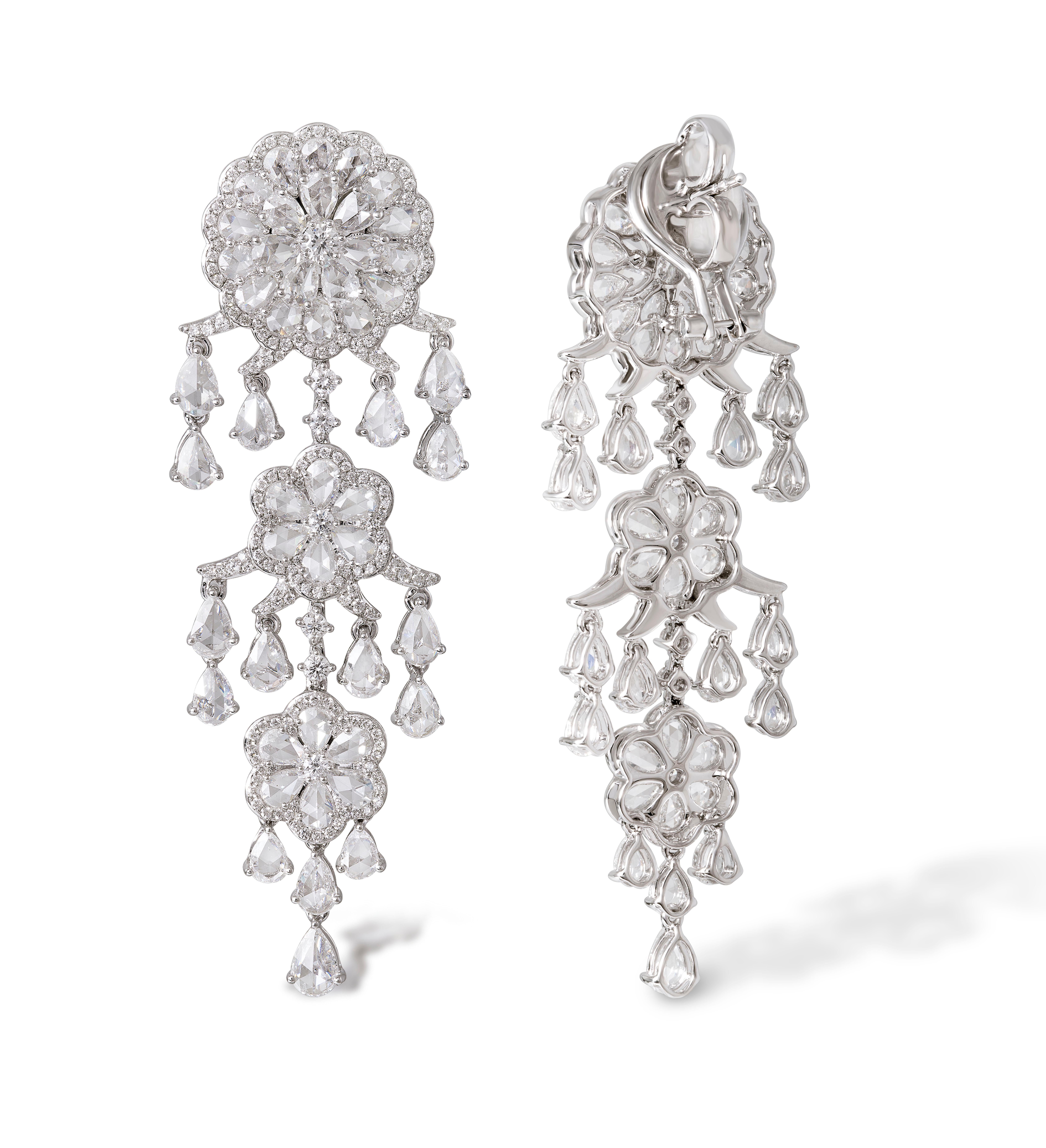Taking inspiration from the unmistakable beauty of the flower, these earrings are crafted with 68 pear shape,  rose-cut diamonds surrounding a round brilliant cut diamond to form the floral motif. 
Handcrafted from lightly hammered 18-karat gold and
