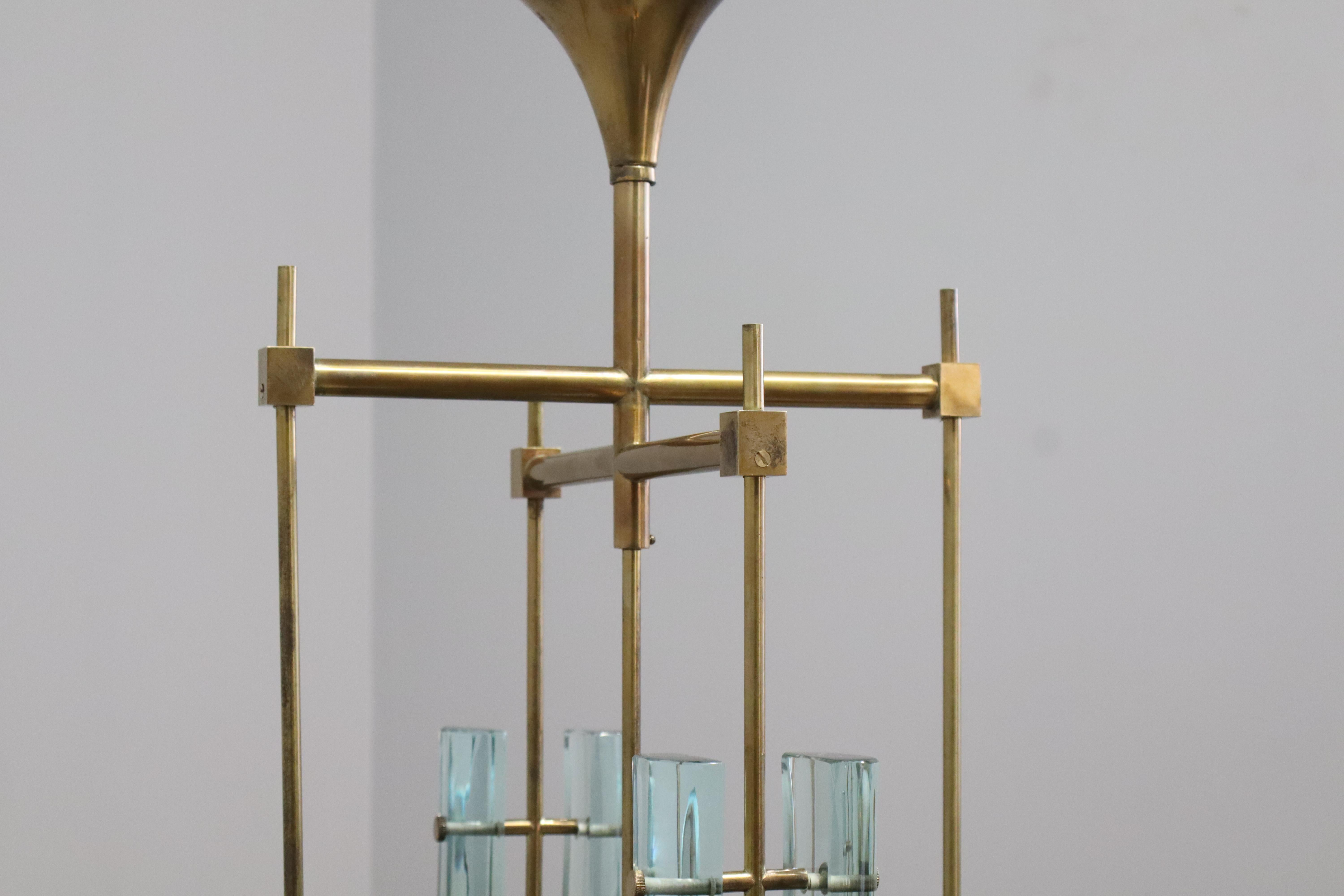 Max Ingrand for Fontana Arte rare chandelier or ceiling light model 2338 with five polished teardrop shaped double glass shades with partial sand-blasted centers suspended by brass structure and stems with original canopy, Italy, 1960s. 
This